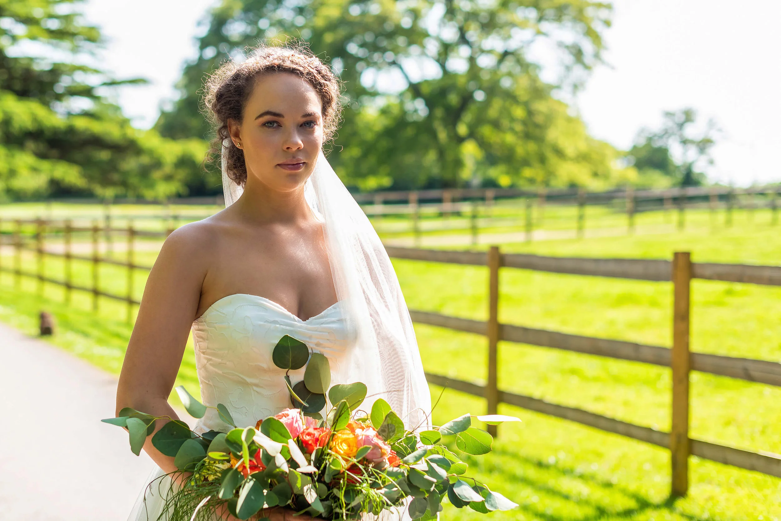 Bride in Oui Madam Bridal Atelier dress, with Davina Simone Weddings floral and foliage bouquet and Sash & Veil Bridal veil at Nurstead Court Wedding Venue, Kent.