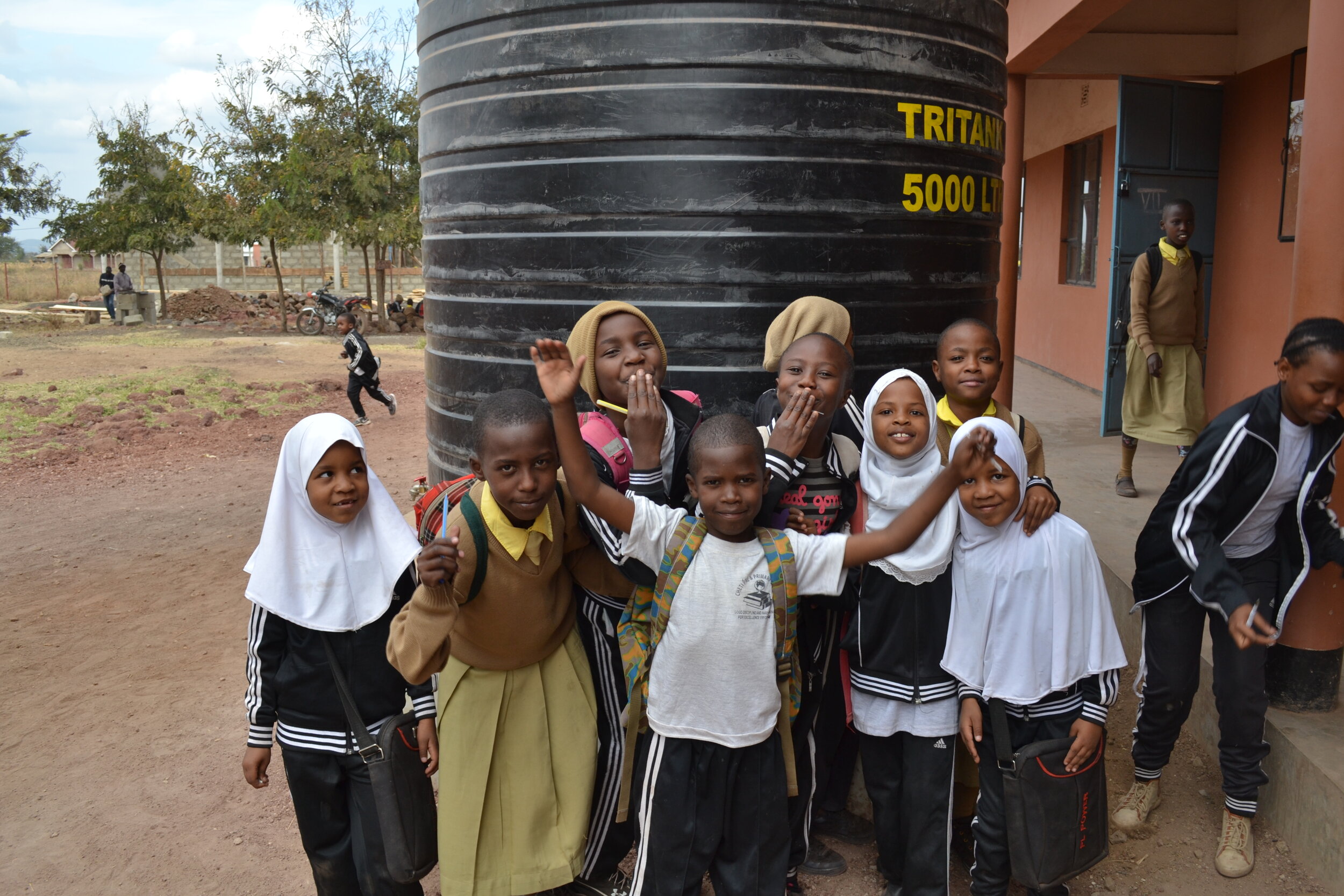 Students celebrate a new water tank