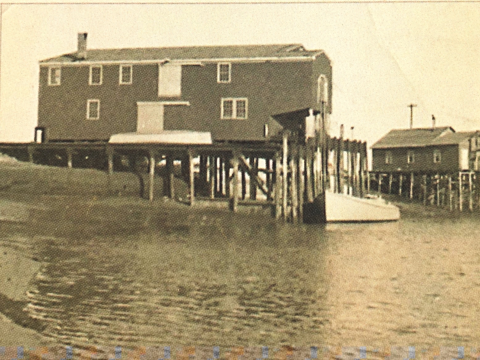 Looking from the north at Goulart and Rupkus building. Side view showing ramp with banana boat. Nets would be pulled onto a truck with a winch.