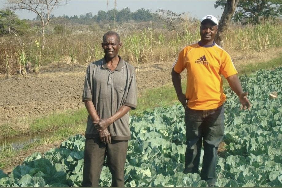 Maxwell Chikuta with a farmer in Zambia
