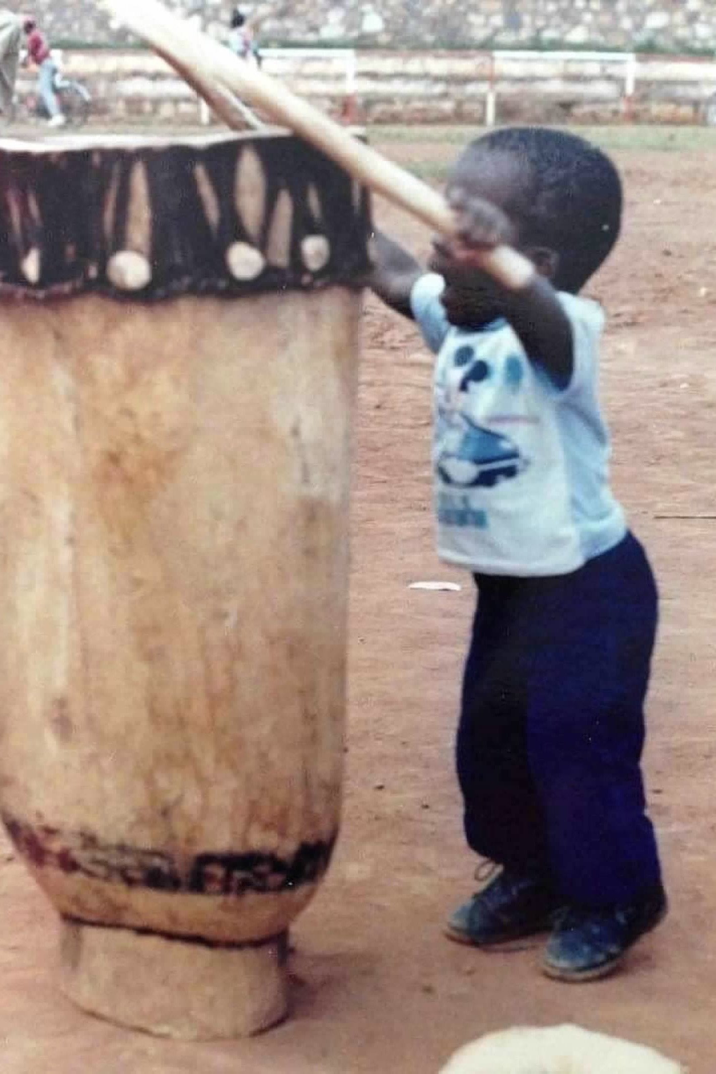 Mike Kanakan, about 18 months, beating the Burundi Drum at a Cultural Fair in Gitega, Burundi