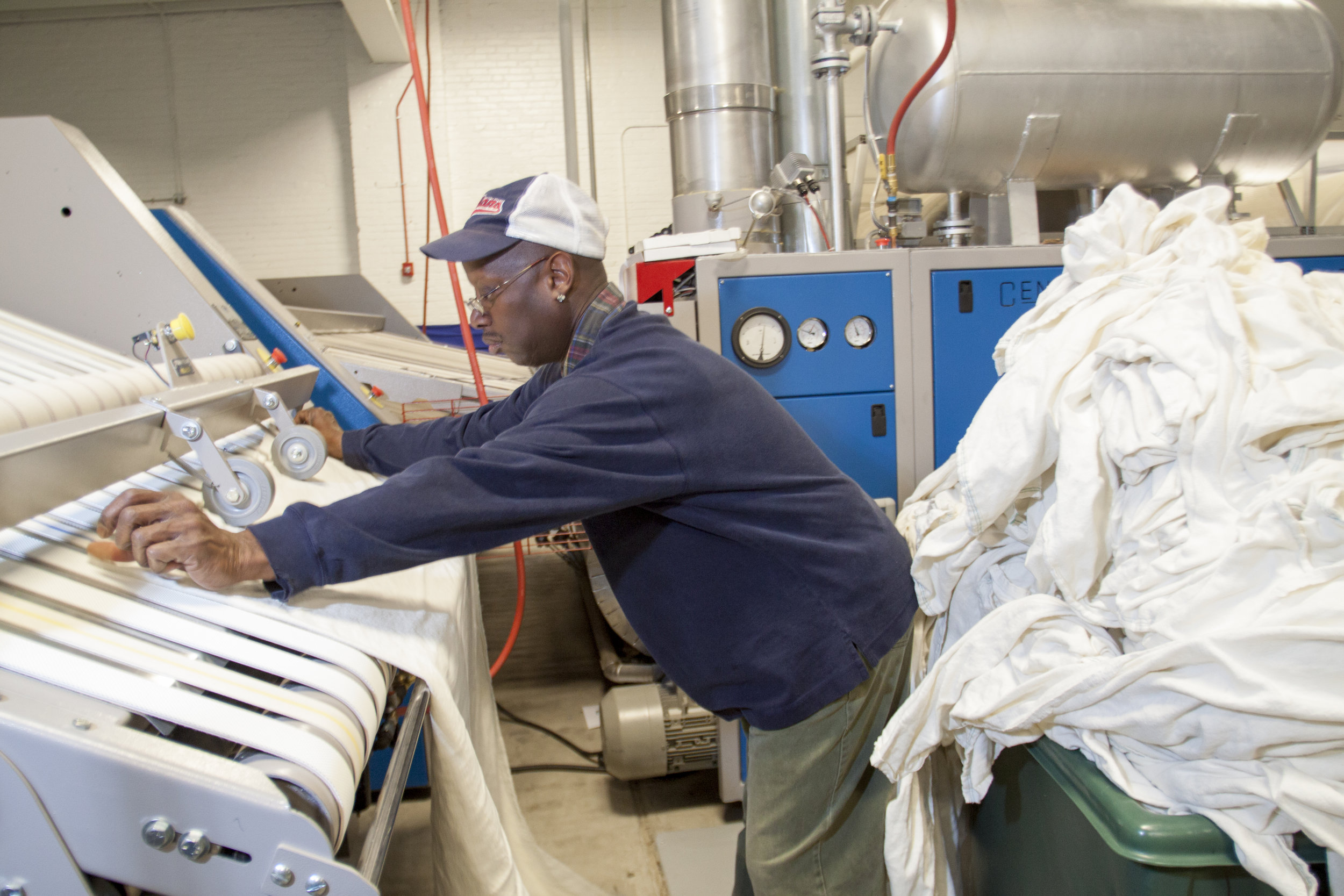  An employment program trains University Circle neighbors to work in Evergreen Laundry, one of three cooperatives that serve the main anchor institutions.   
