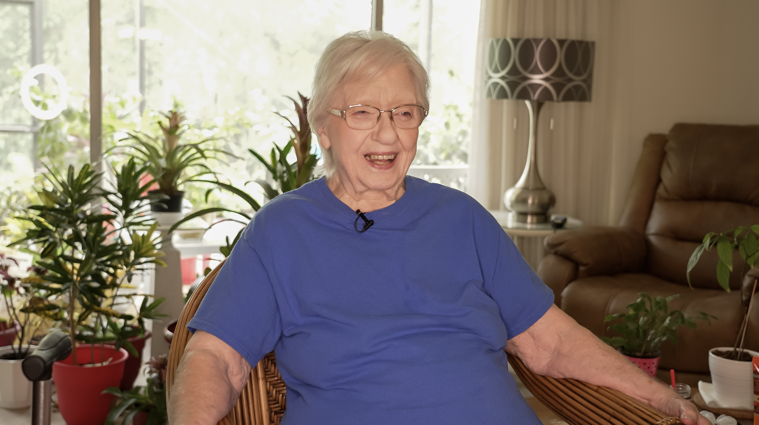 Image of a senior citizen smiling widely while reminiscing their stories from life.