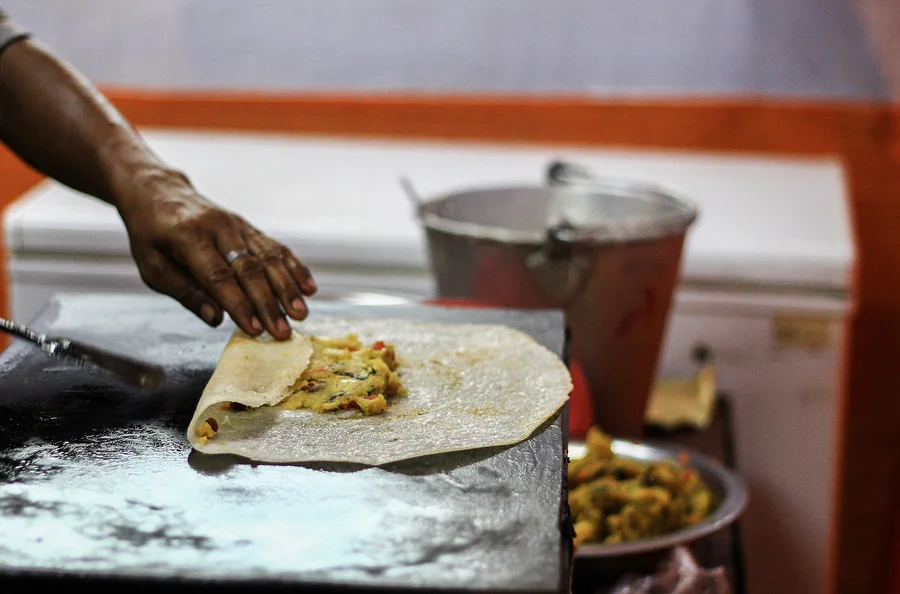 bigstock-Folding-Dosa-After-Adding-Pota-250425892.jpg