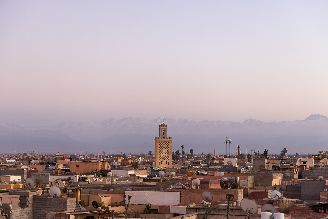 Leaning over a terrace railing, taking in the sunset. Light passes over mountains, mosques, and rooftops. Colours deepen. Imams pray over each other through loudspeakers. City lights flicker on in unison. I set my glass of tea on a mosaic table to sn