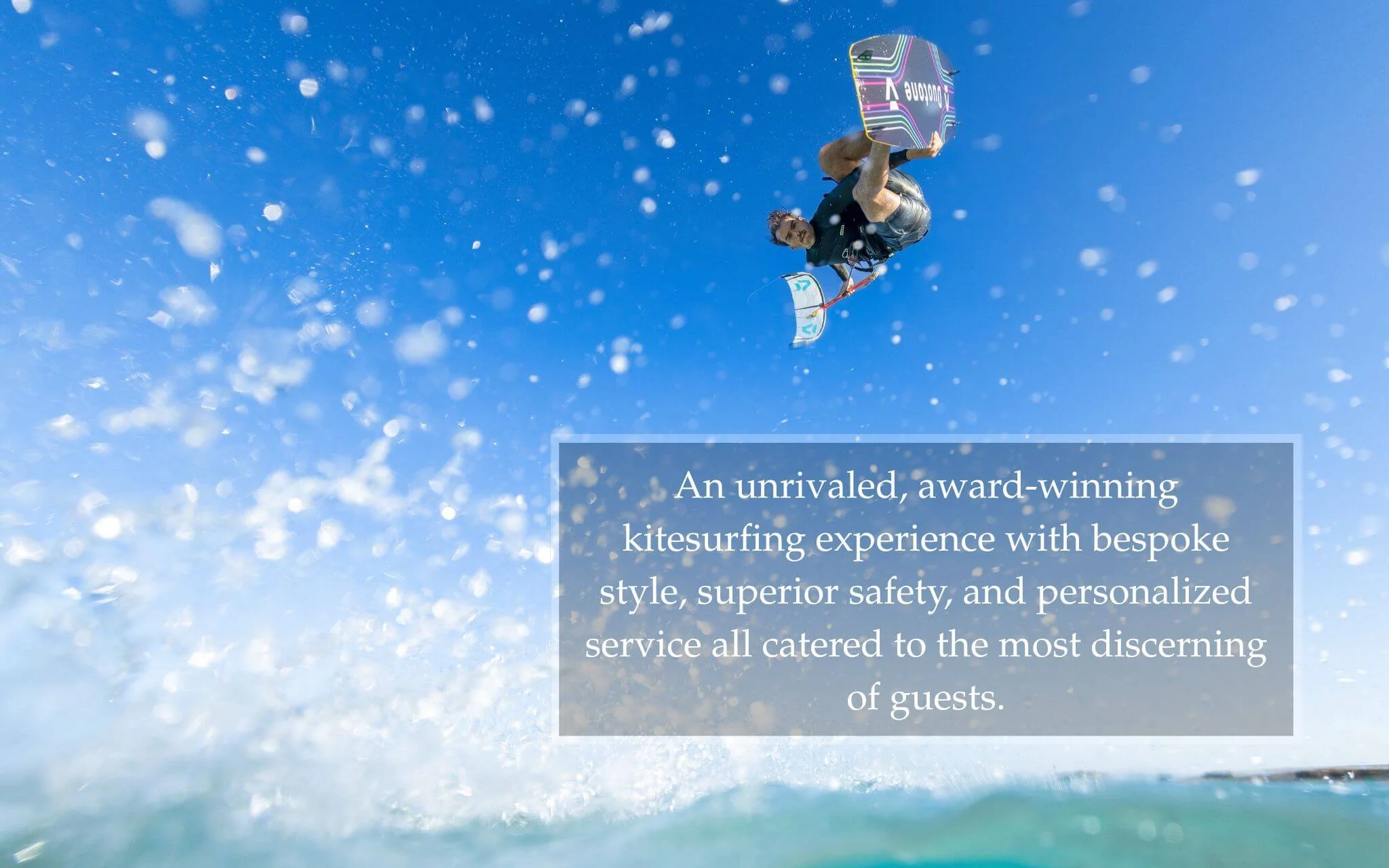 Professional kitesurfer riding the flat, butter-smooth waters of Tawila Island during a Dragonfly luxury kite cruise and kite safari