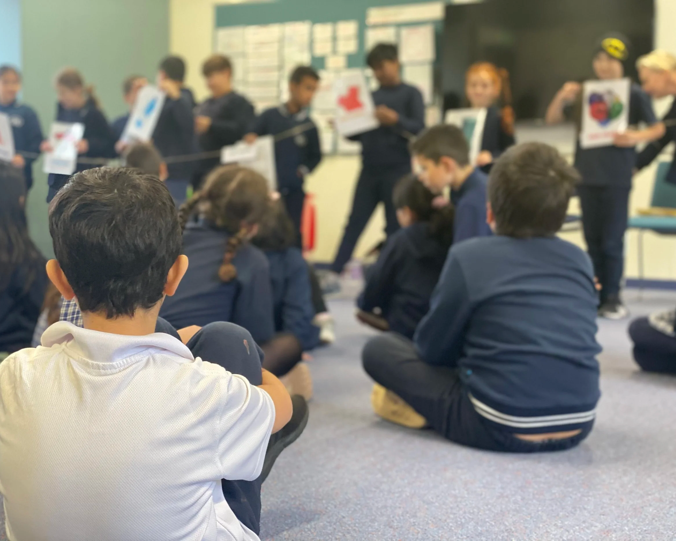 kids sitting on classroom floor looking at a timeline