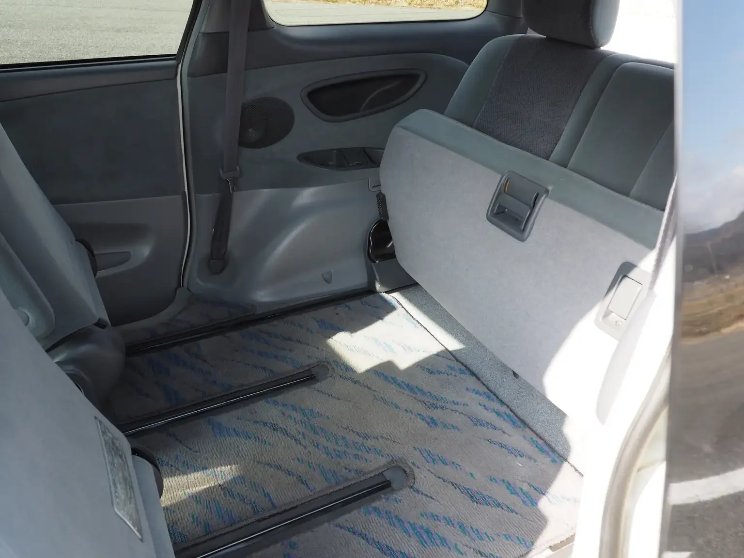 Interior shot of 3rd row seat in grey folded to make additional room for 2nd row seats to slide back further 2001 Toyota Estima Aeras L Japan export inventory for sale