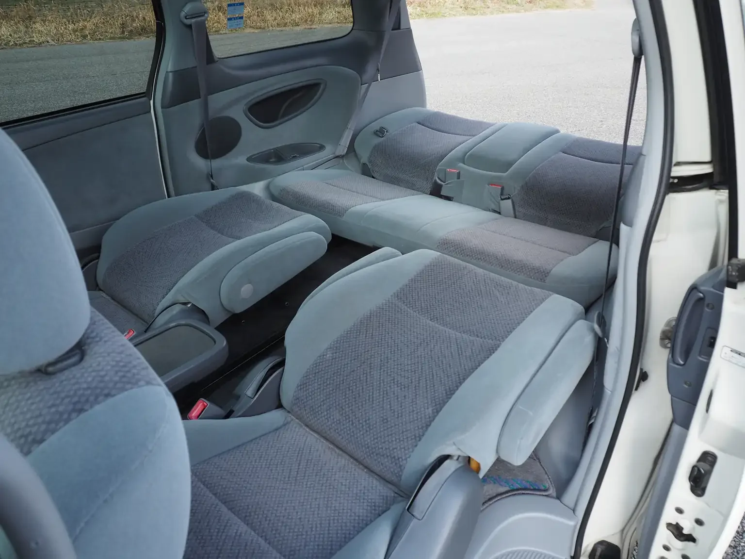 Interior shot of 2nd and 3rd row seats folded to make a lay flat bed 2001 Toyota Estima Aeras L Japan export inventory for sale