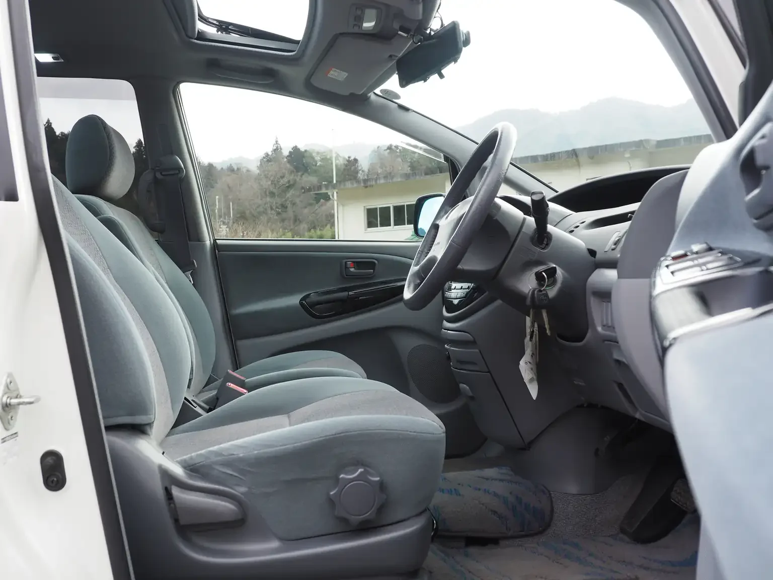 Interior shot side view of grey front drivers seat 2001 Toyota Estima Aeras L Japan export inventory for sale
