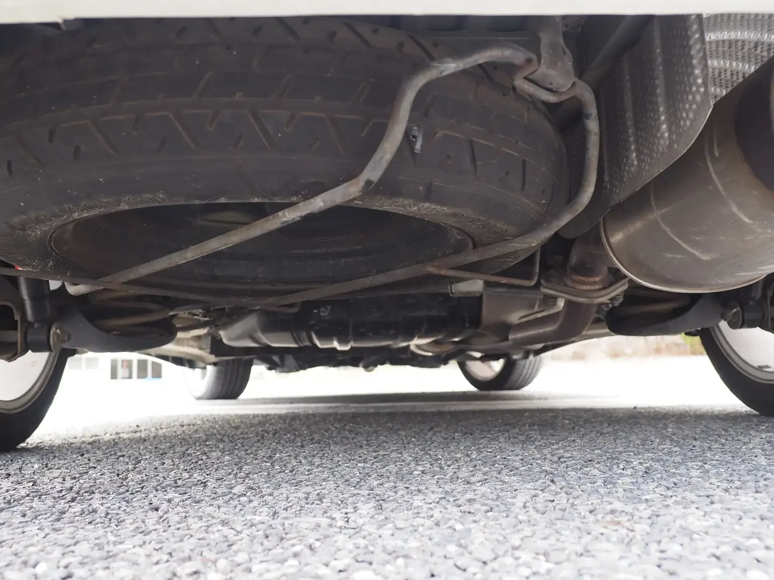 undercarriage shot rust free and original condition floor pan with spare tyre installed in good condition 2001 Toyota Estima Aeras L Japan export inventory for sale