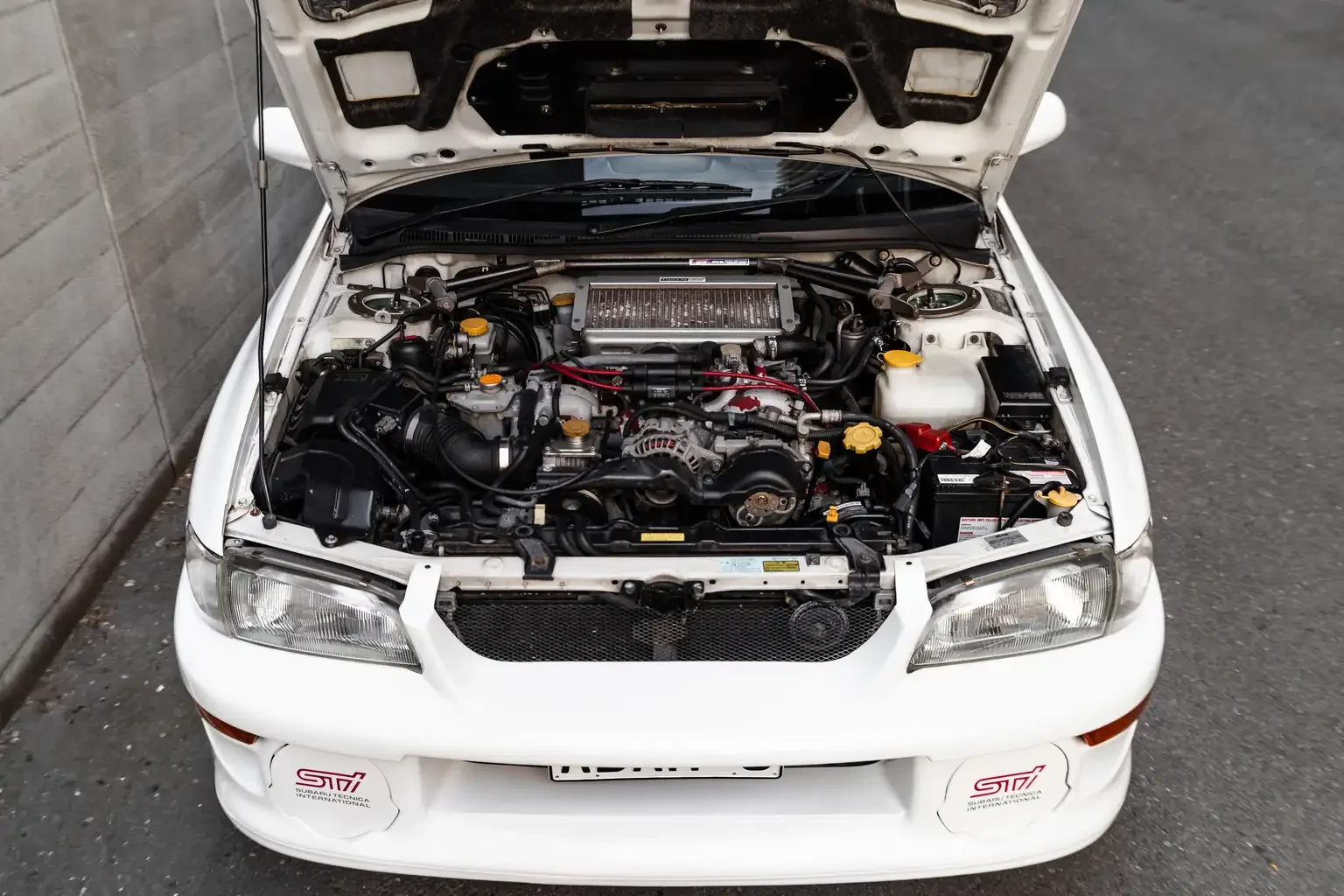 bonnet open showing ej20 turbo engine bay gc8 subaru impreza WRX STi version 4 1998 JDM vehicle for export sale New Zealand