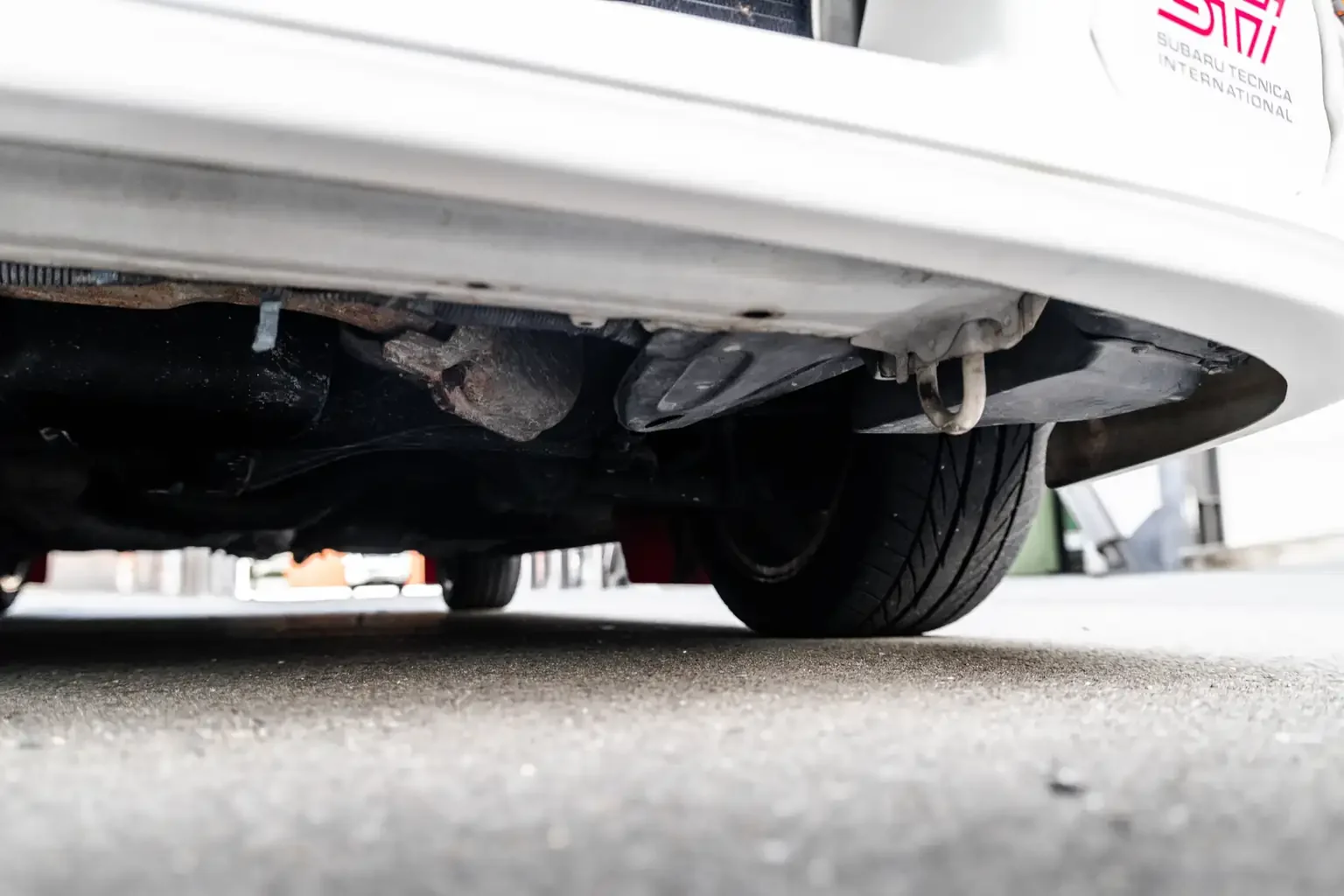 front left undercarriage inspection showing rust and oil leak free underside on gc8 subaru impreza WRX STi version 4 1998 JDM vehicle for export sale New Zealand