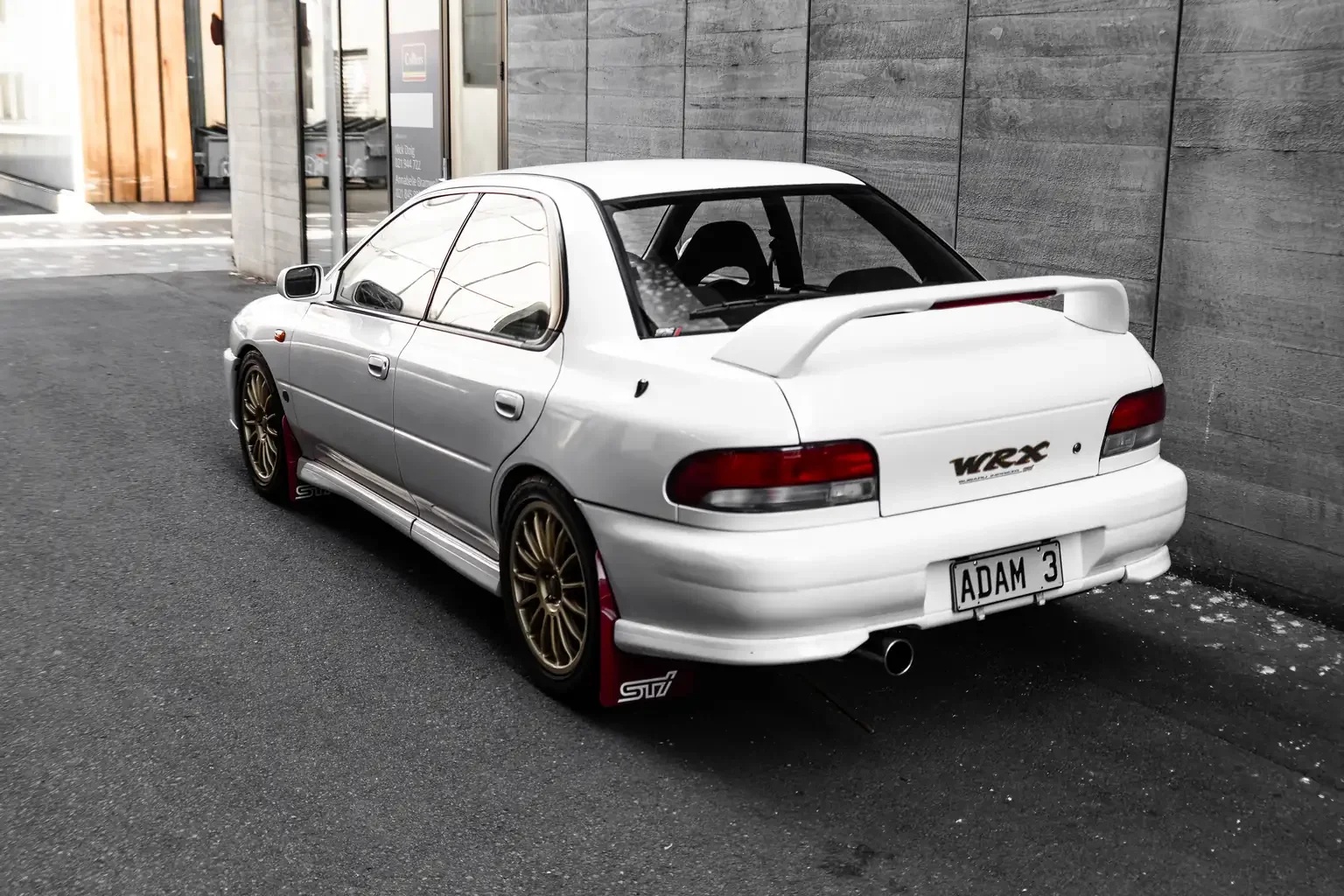 passengers rear quarter side shot on feather white gc8 subaru impreza WRX STi version 4 1998 JDM vehicle for export sale New Zealand
