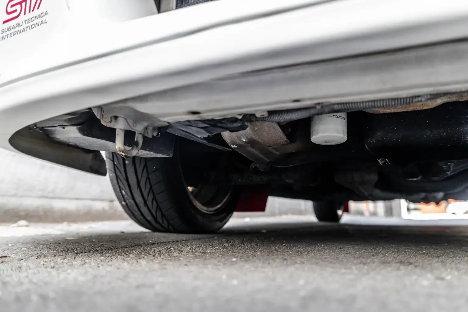 front right undercarriage shot showing rust free gc8 subaru impreza WRX STi version 4 1998 JDM vehicle for export sale New Zealand
