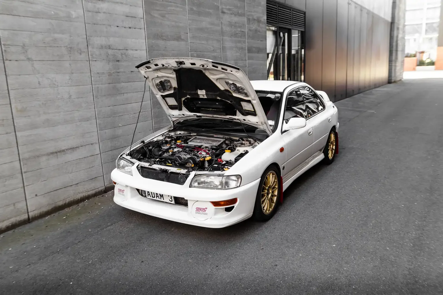 front passengers view with bonnet open showing ej20 turbo engine on white gc8 subaru impreza WRX STi version 4 1998 JDM vehicle for export sale New Zealand