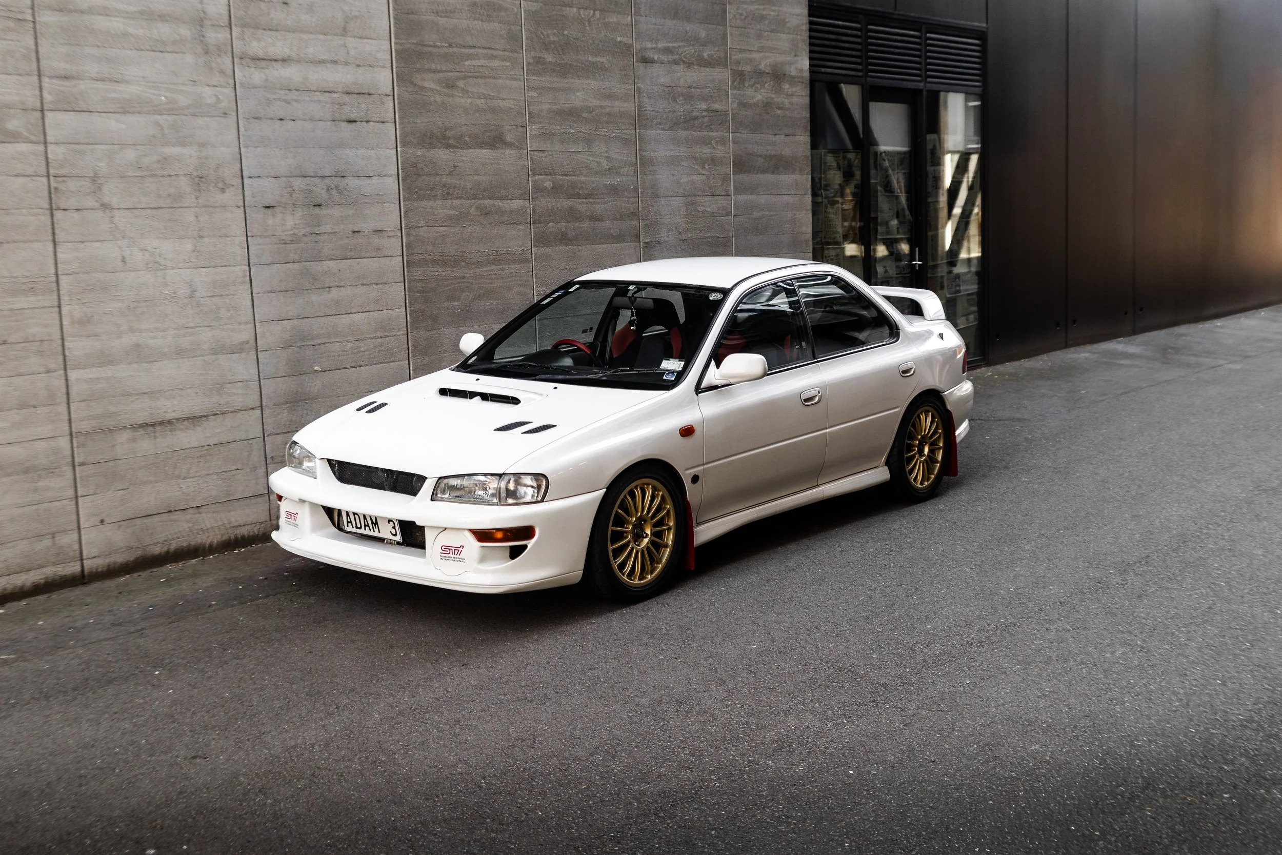 Front angle side shot of feather white gc8 subaru impreza WRX STi version 4 1998 JDM vehicle for export sale New Zealand