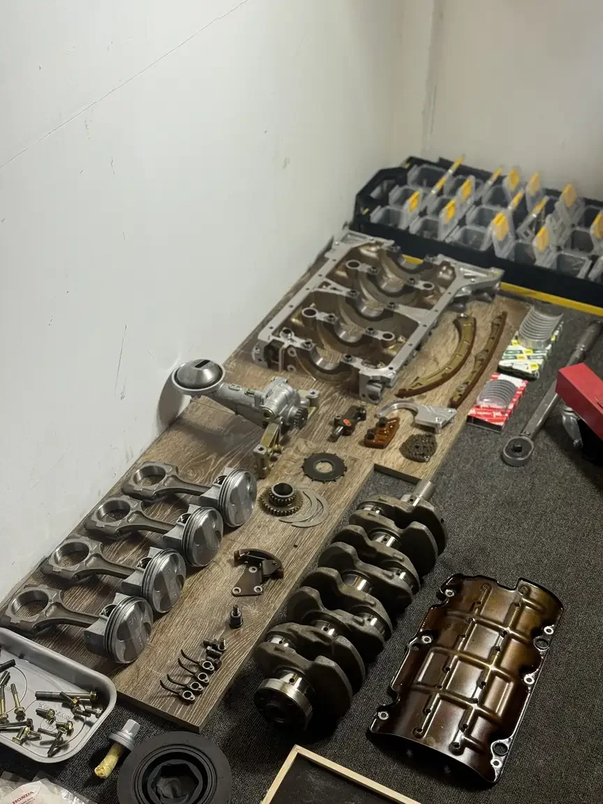 K20A engine stripped down and laid out on parts bench 2001 DC5 Honda Integra Type R JDM export vehicle for sale New Zealand