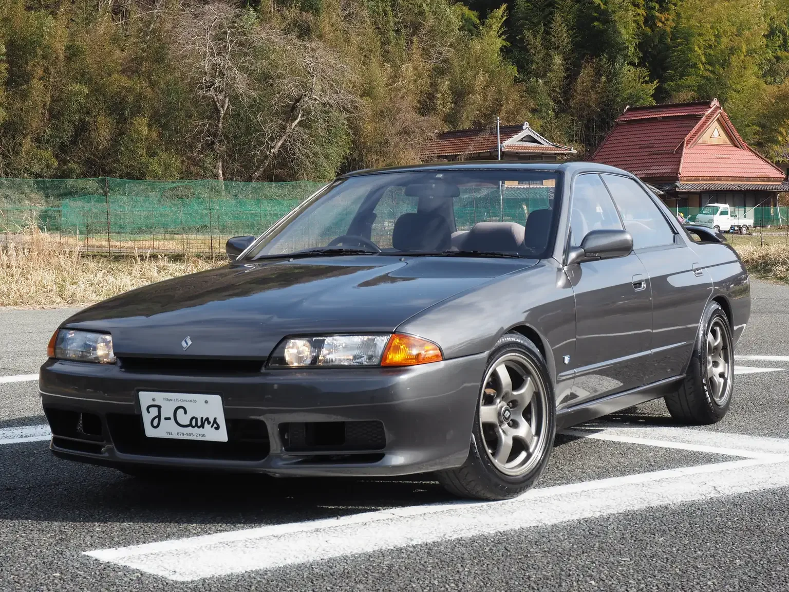 Front passengers side view of a grey 1991 Nissan Skyline GTS25 Type X G 4 Door Sedan for export from Japan