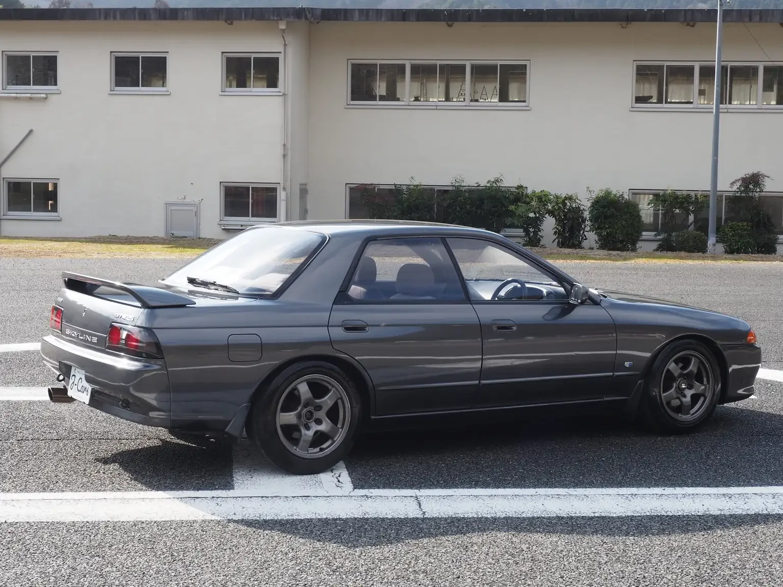 Rear drivers side view 1991 Nissan Skyline GTS25 Type X G 4 Door Sedan with GTR wheels for export from Japan