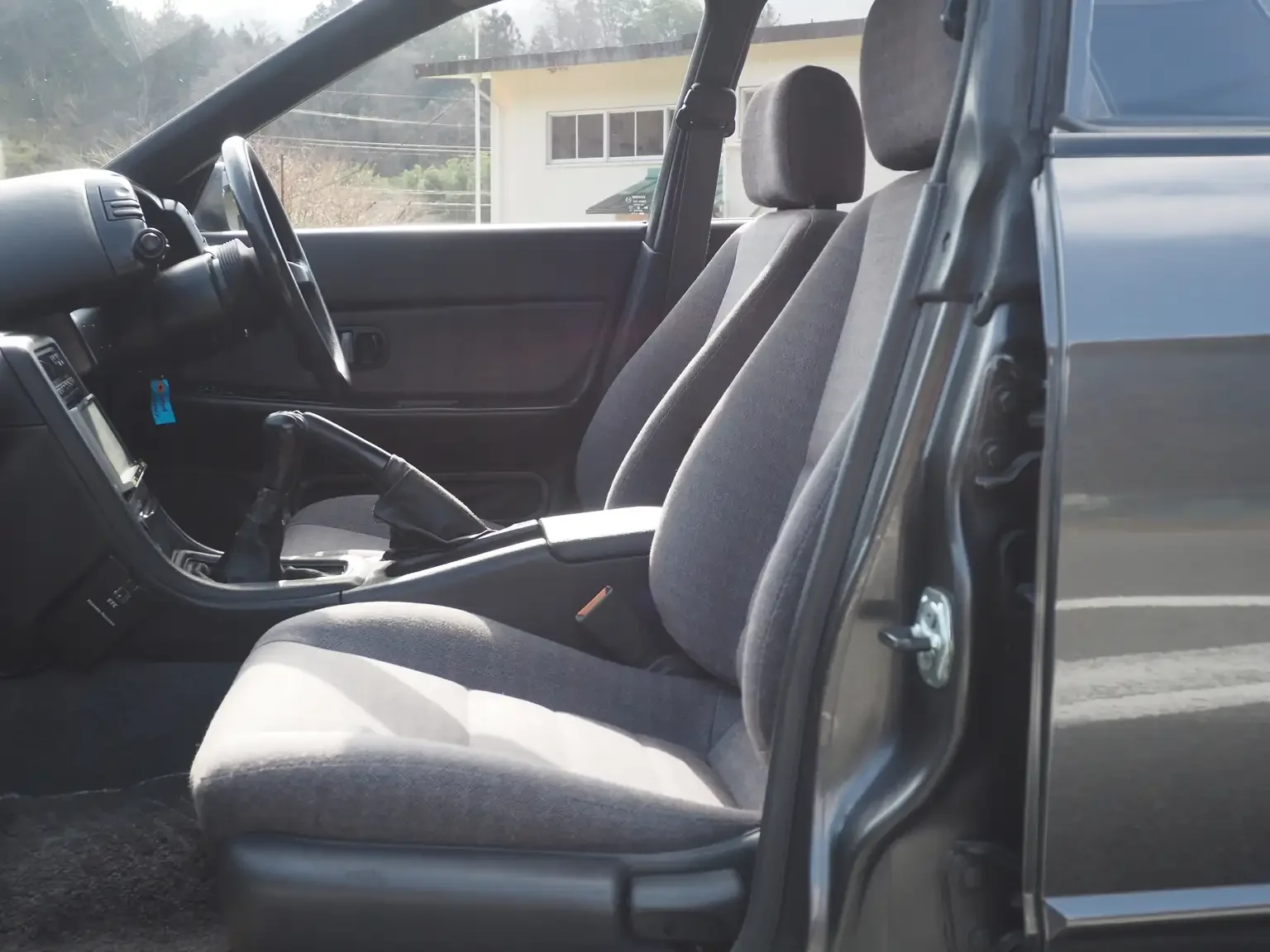 Interior passengers side view of grey cloth type x g seats 1991 Nissan Skyline GTS25 Type X G 4 Door Sedan for export from Japan
