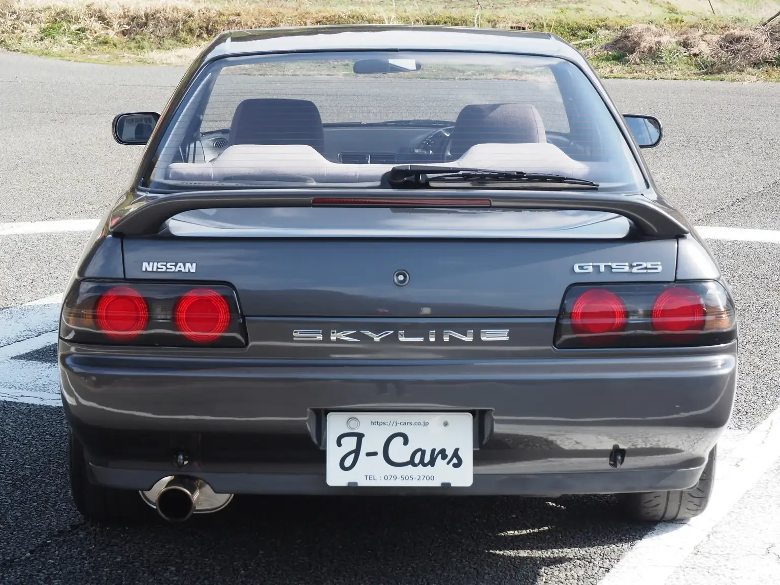 Rear end view of a grey 1991 Nissan Skyline GTS25 Type X G 4 Door Sedan for export from Japan