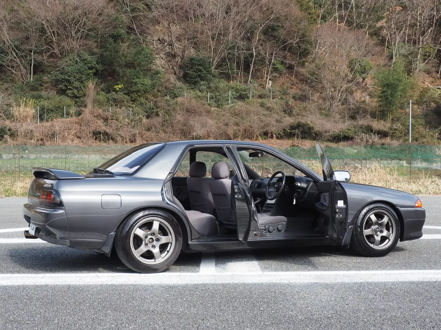 Side view grey 1991 Nissan Skyline GTS25 Type X G 4 Door Sedan with doors open for export from Japan