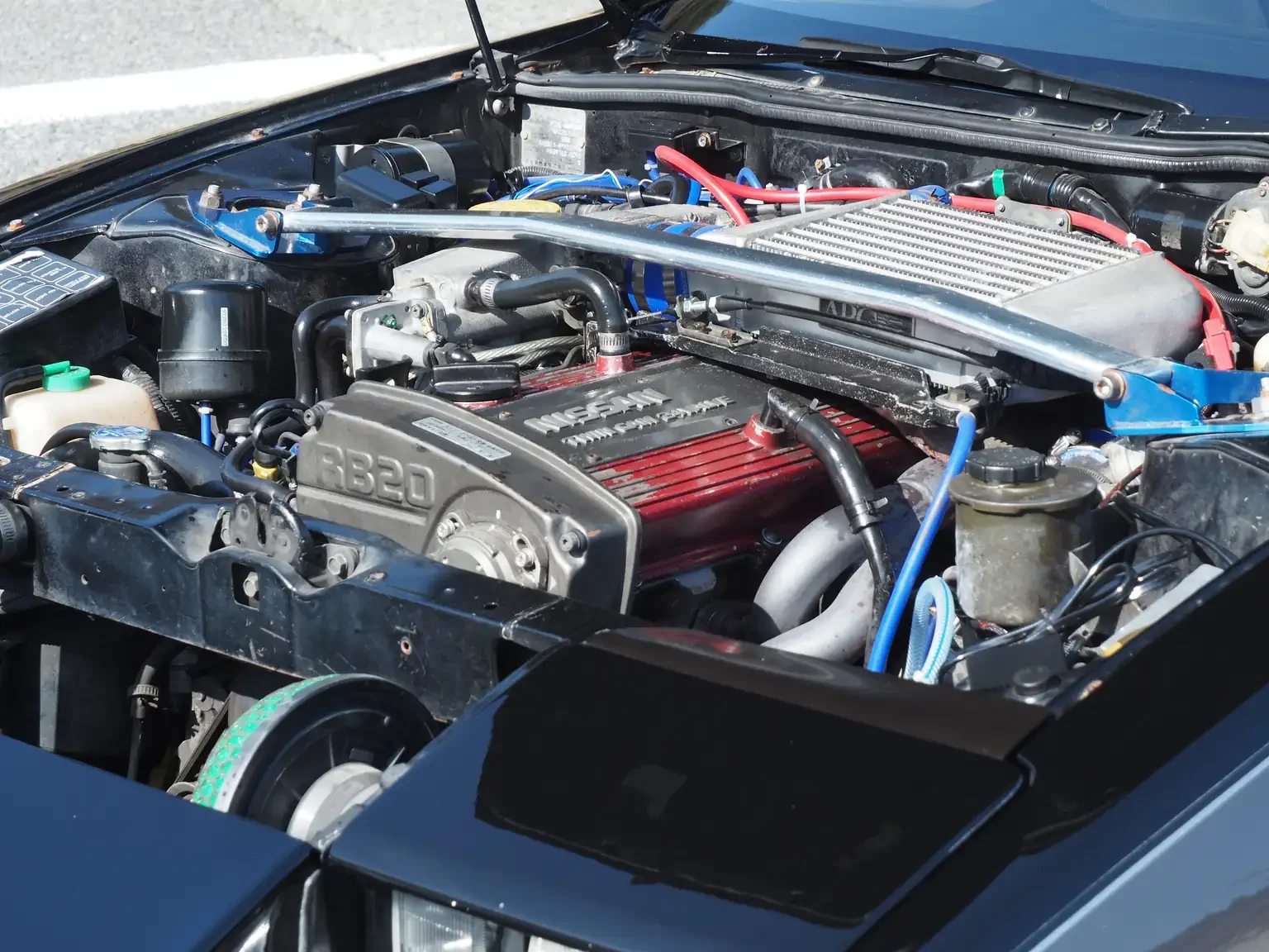 Front view with bonnet open showing modified rb20det engine in Nissan 200zr JDM for export from Japan