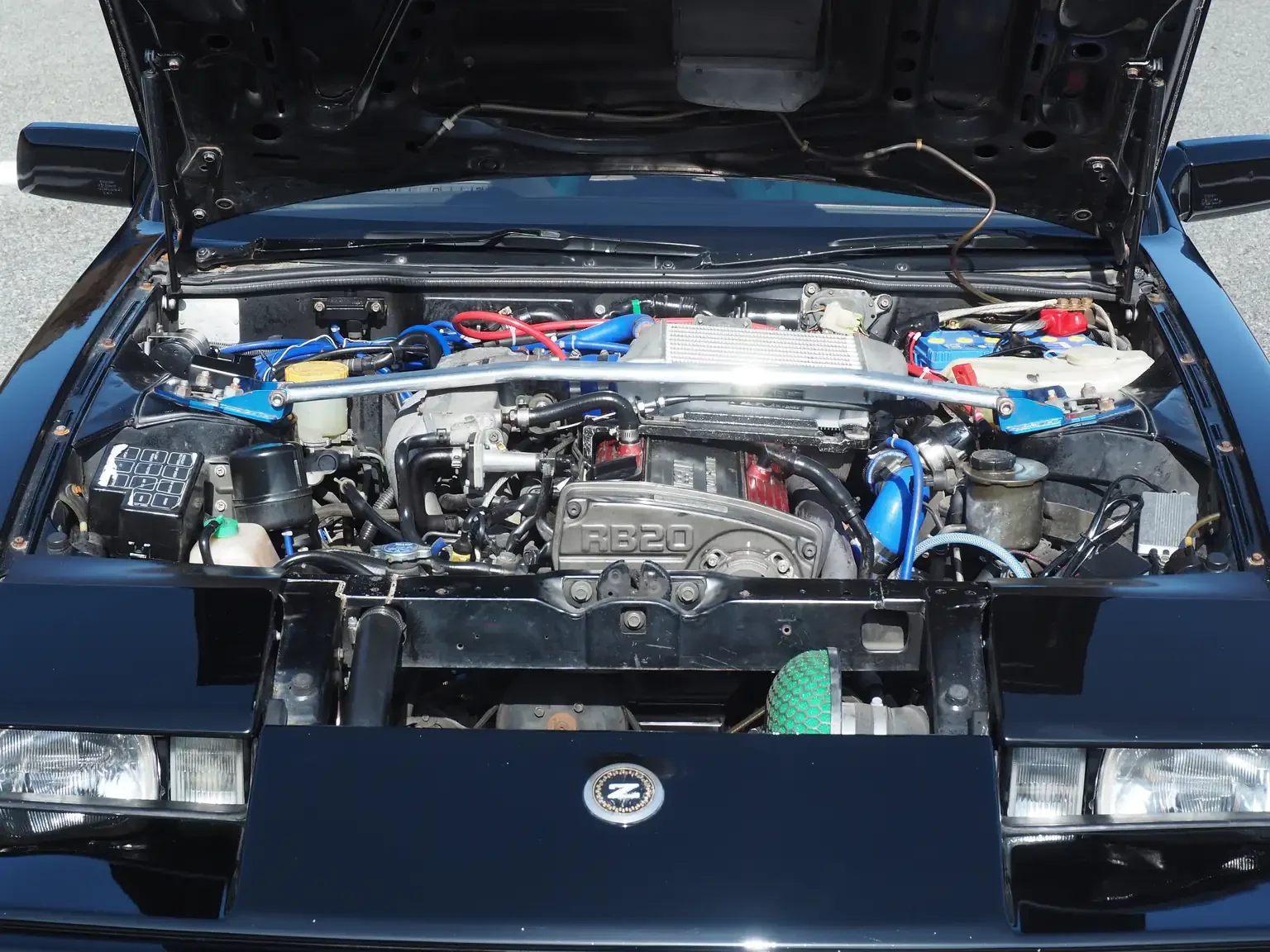 Front view with bonnet open showing modified rb20det engine black 1985 nissan fairlady z 200zr ii JDM classic for export from Japan