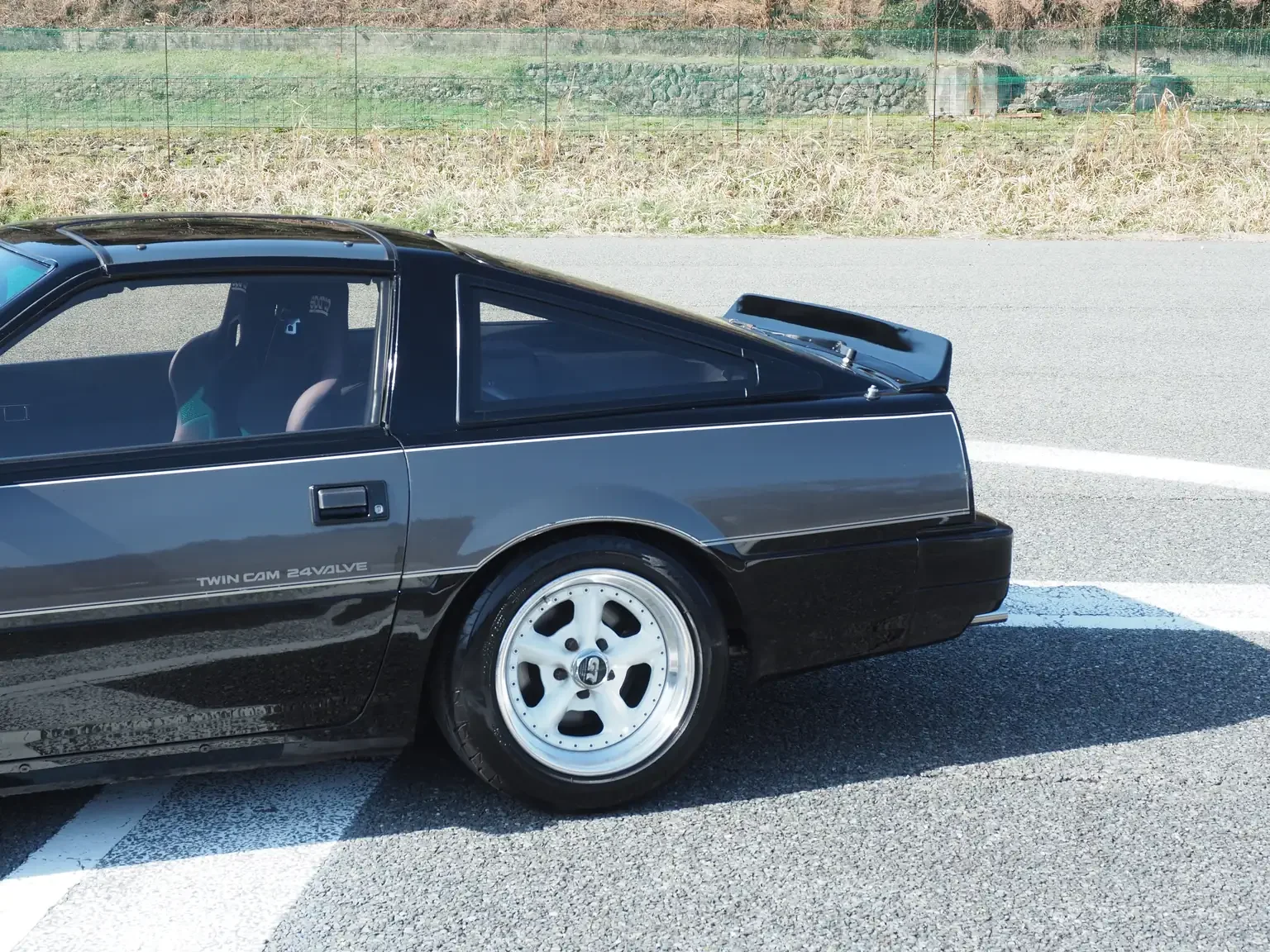 exterior view front drivers side rear quarter panel black and grey two tone Nissan fairlady z 200zr 2 seater JDM for export from Japan