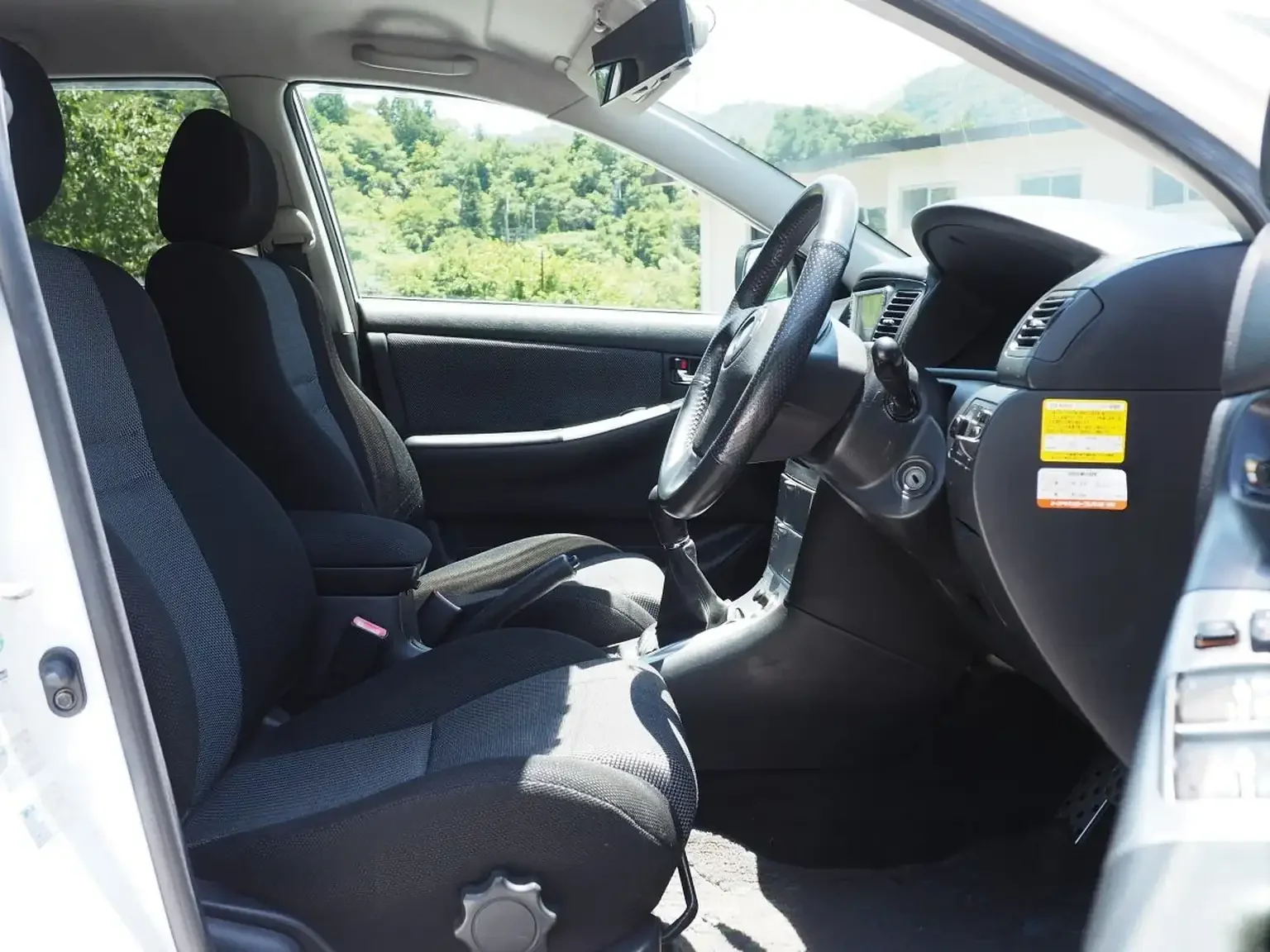 interior view of drivers seat toyota corolla runx aero tourer z 6 speed zze123 JDM export stock for sale japan