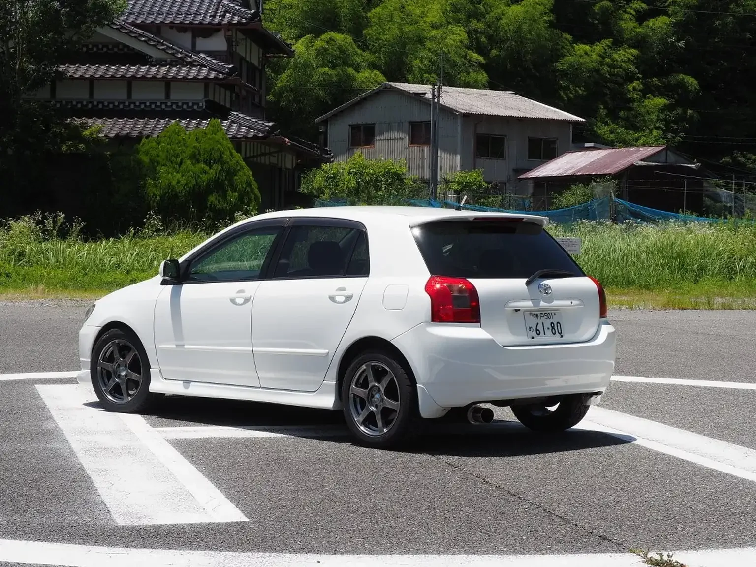 rear passengers side angle view of apexi exhaust on white toyota corolla runx aero tourer z 6 speed zze123 JDM export stock for sale japan