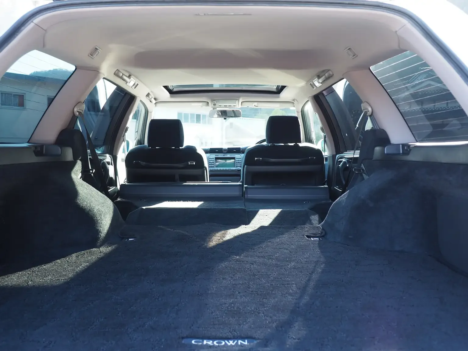 rear luggage area view with rear seats folded down charcoal interior pearl white toyota crown athlete four estate 2001 jdm export stock japan