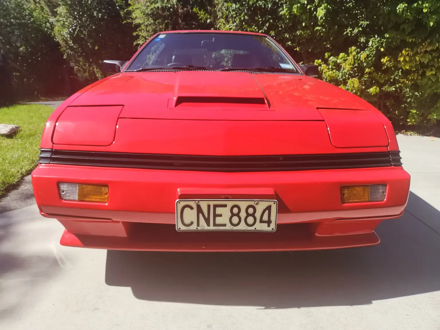 Front end view red Mitsubishi Starion GSR II Turbo JDM spec NZ New export vehicle for sale New Zealand