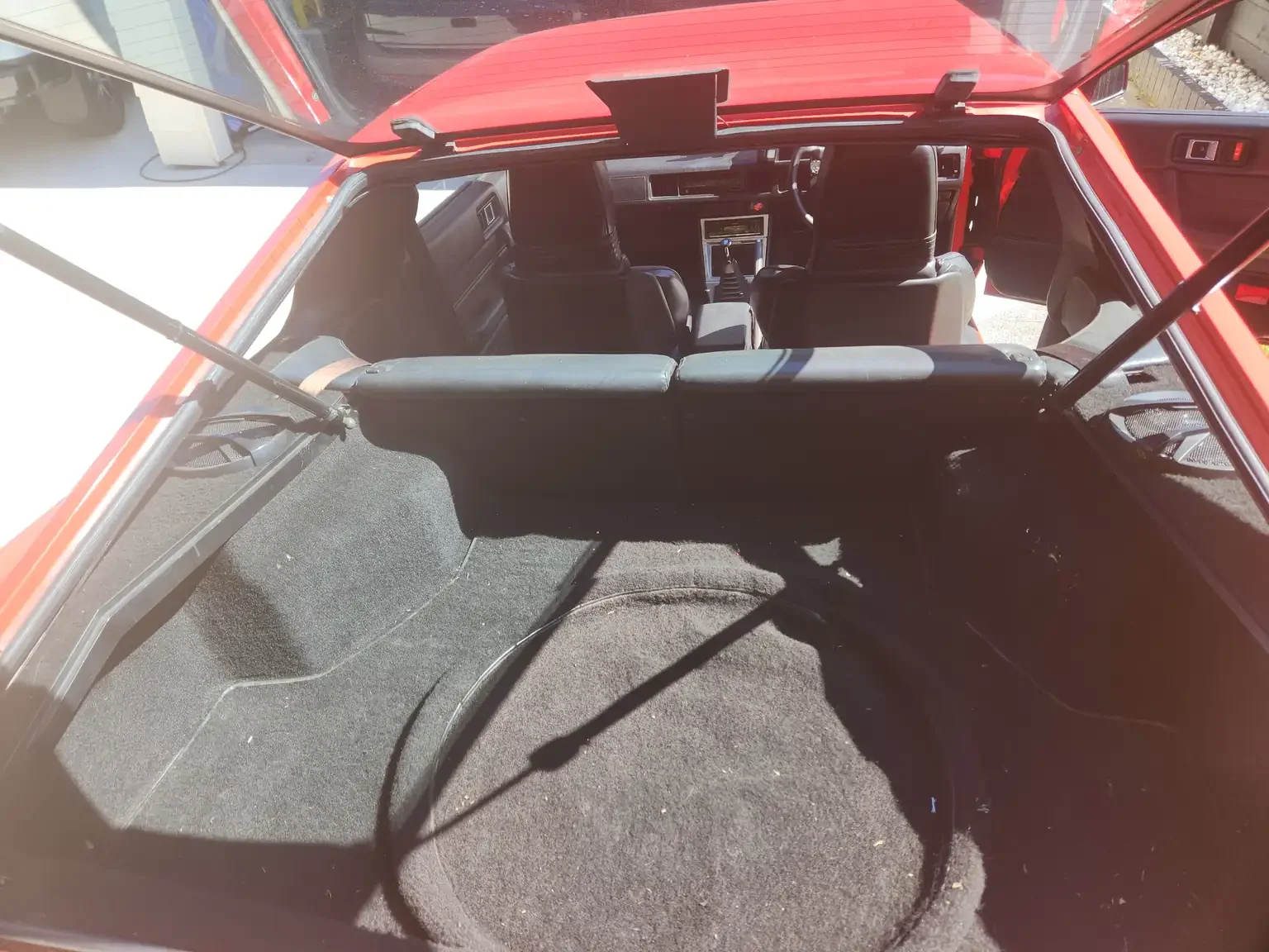 rear-hatch-carpet-condition-view-1983-mitsubishi-starion-gsr-ii-5-speed-manual-red-jdm-export-vehicle-new-zealand.webp