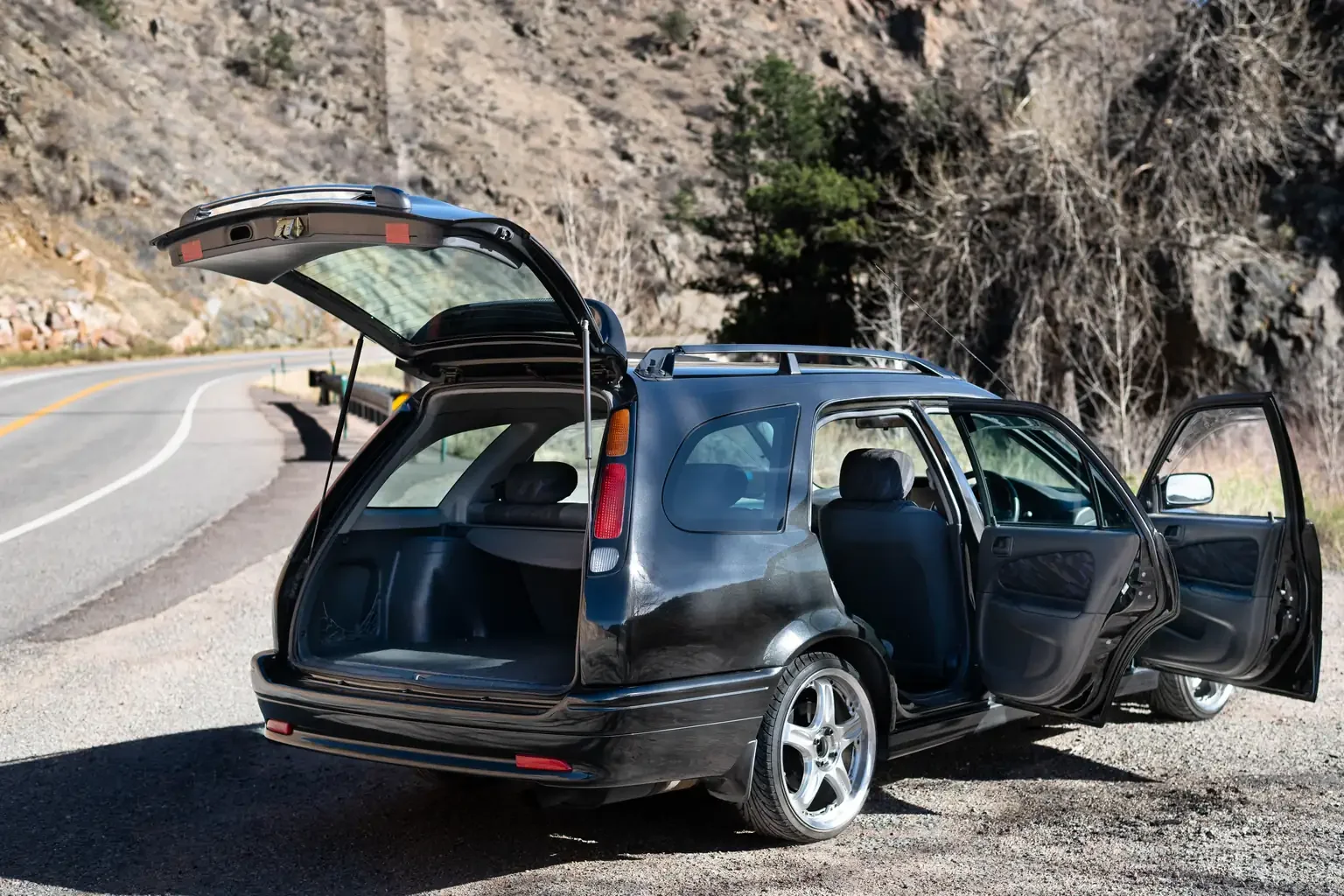 rear drivers side angle view with doors and tailgate open toyota sprinter carib bz touring 4age 6MT black usa legal jdm vehicle with title for sale colorado USA