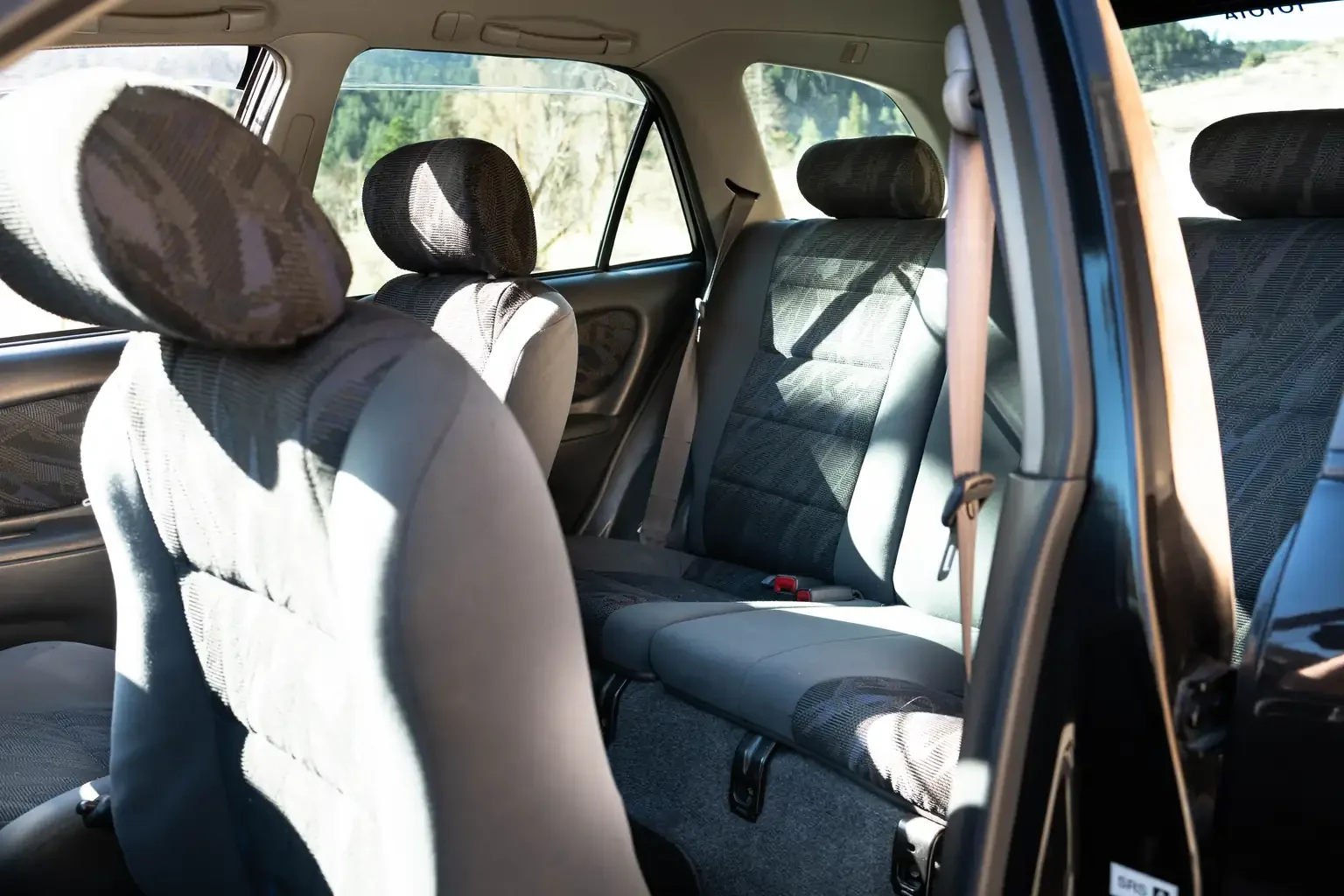 passengers seat folded forward revealing rear seats view toyota sprinter carib bz touring 4age 6MT black usa legal jdm vehicle with title for sale colorado USA