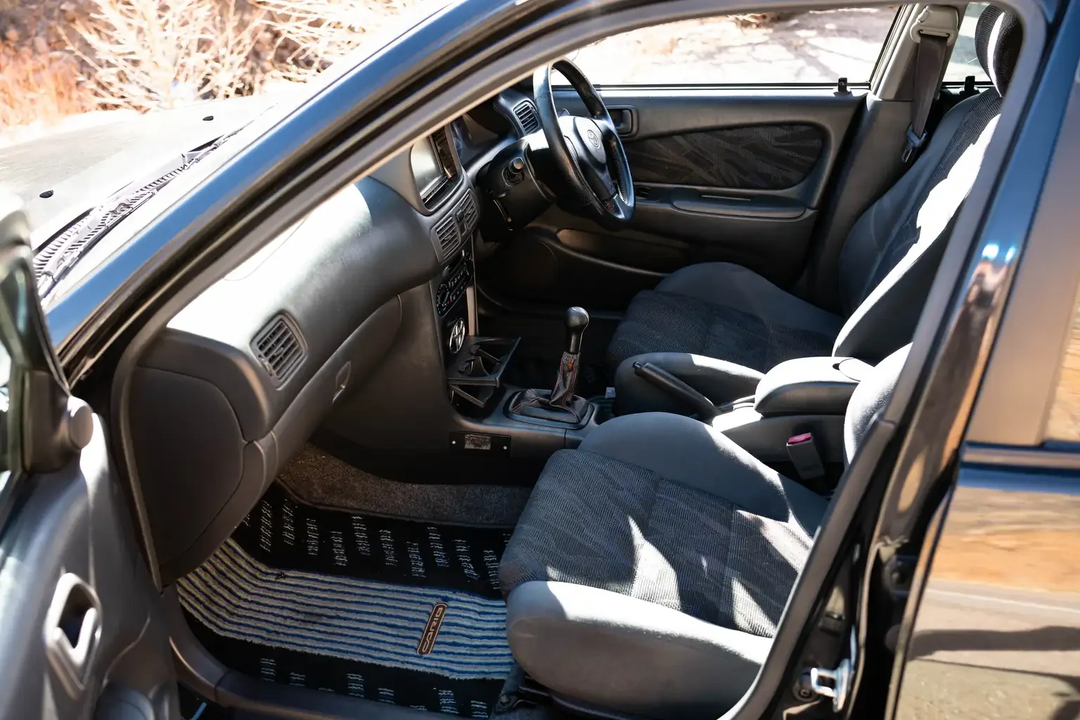 passengers door open showing passengers seat view toyota sprinter carib bz touring 4age 6MT black usa legal jdm vehicle with title for sale colorado USA