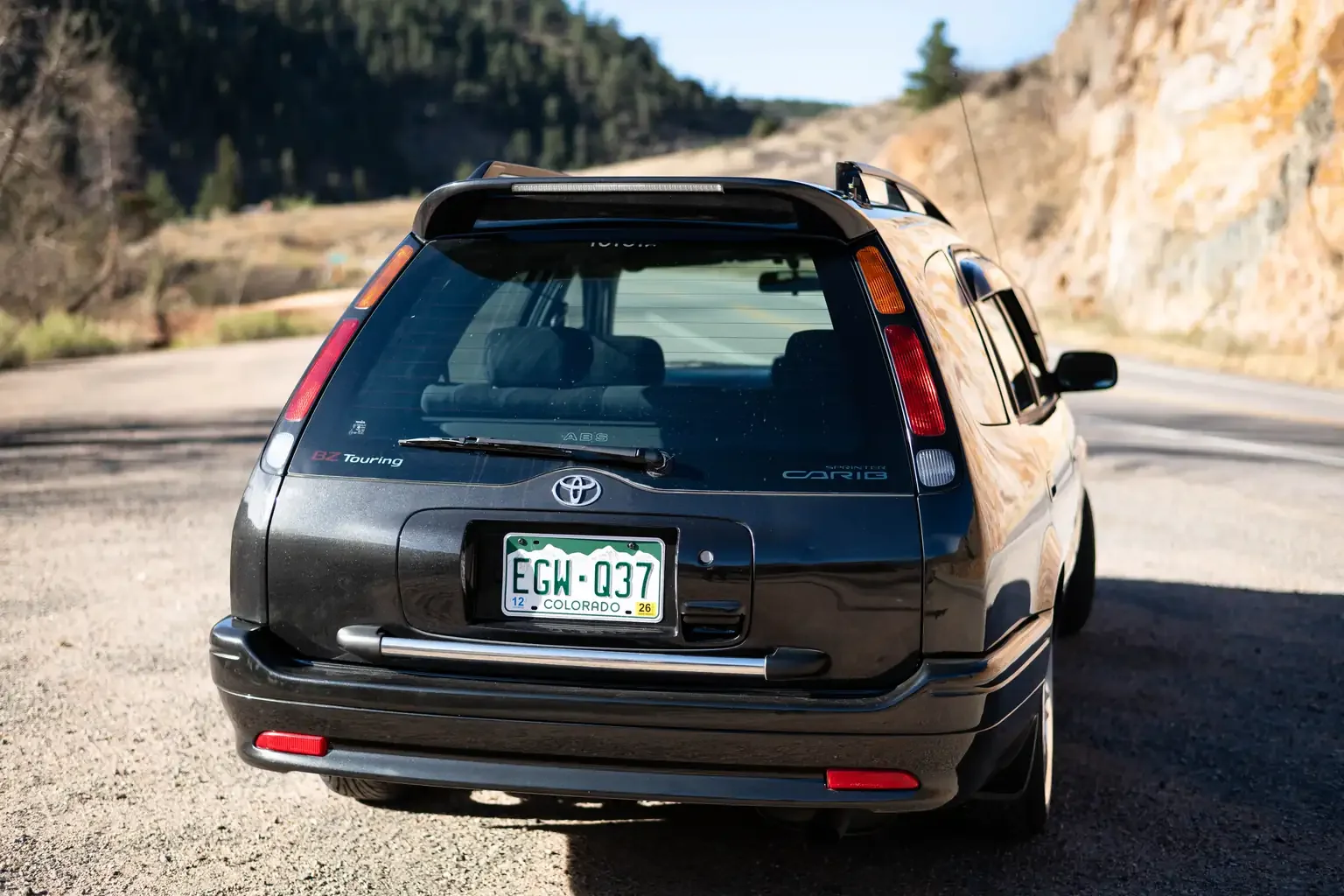 slight angle view of rear end view toyota sprinter carib bz touring 4age 6MT black usa legal jdm vehicle with title for sale colorado USA