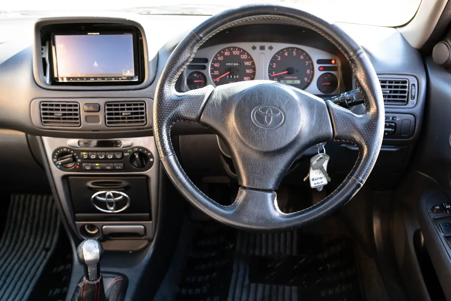 interior view showing steering wheel and instrument cluster view toyota sprinter carib bz touring 4age 6MT black usa legal jdm vehicle with title for sale colorado USA