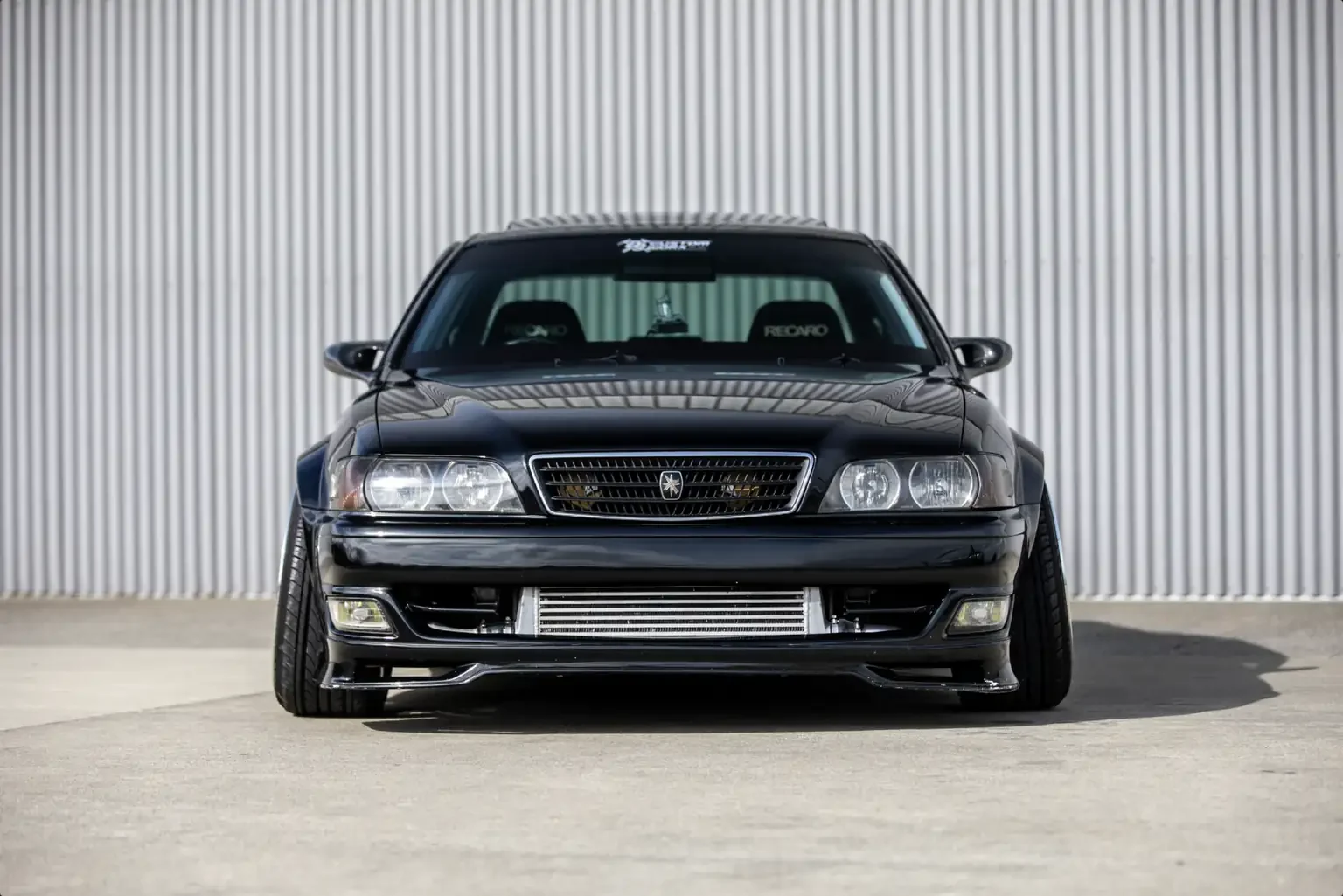 front end view black toyota chaser tourer v jzx100 custom steel wide body jdm export vehicle new zealand