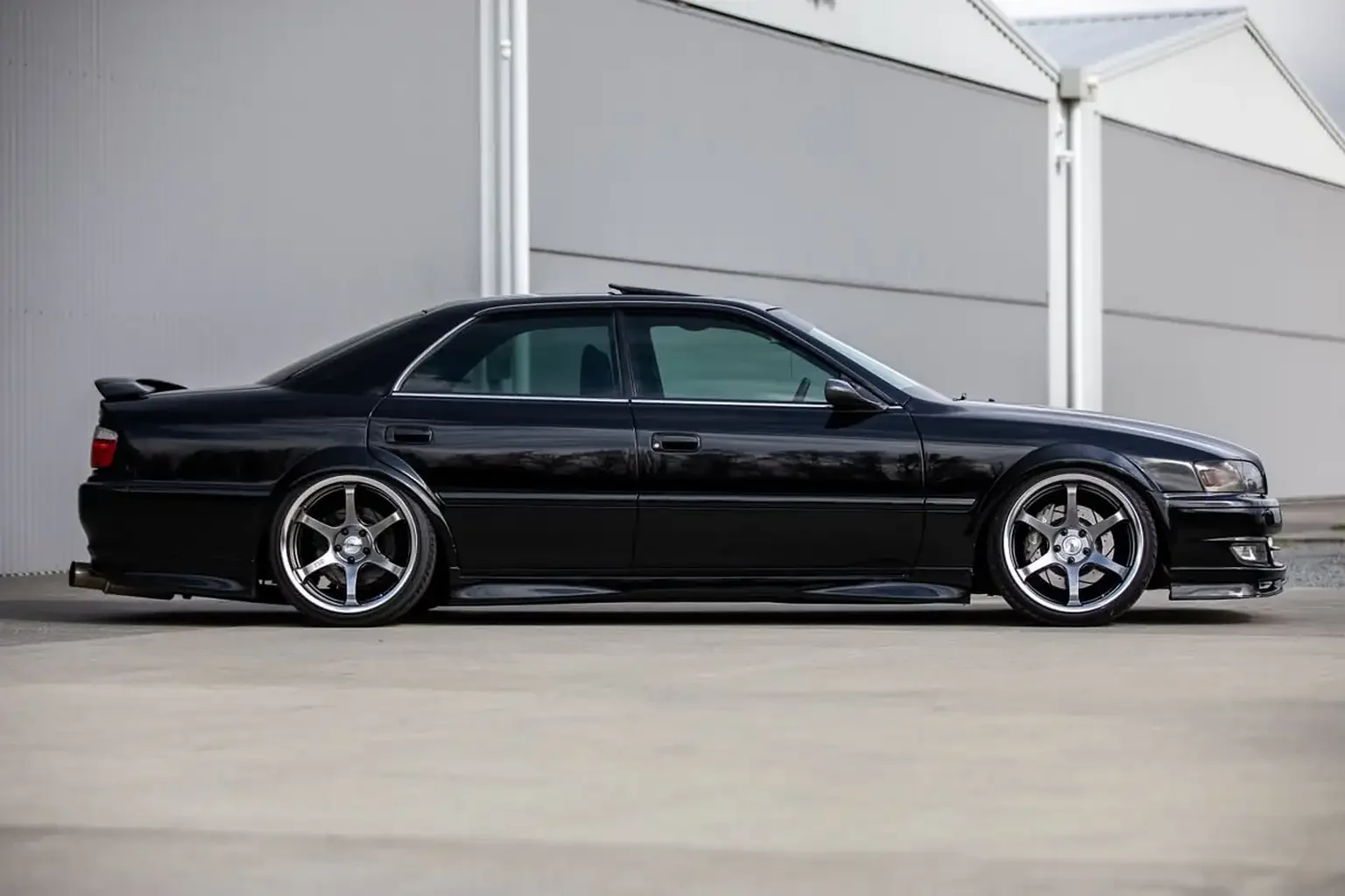 drivers side view view black toyota chaser tourer v jzx100 custom steel wide body jdm export vehicle new zealand