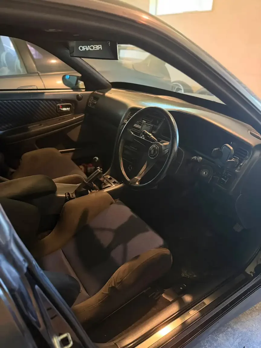 front drivers side door interior peak through view black toyota chaser tourer v jzx100 custom steel wide body jdm export vehicle new zealand