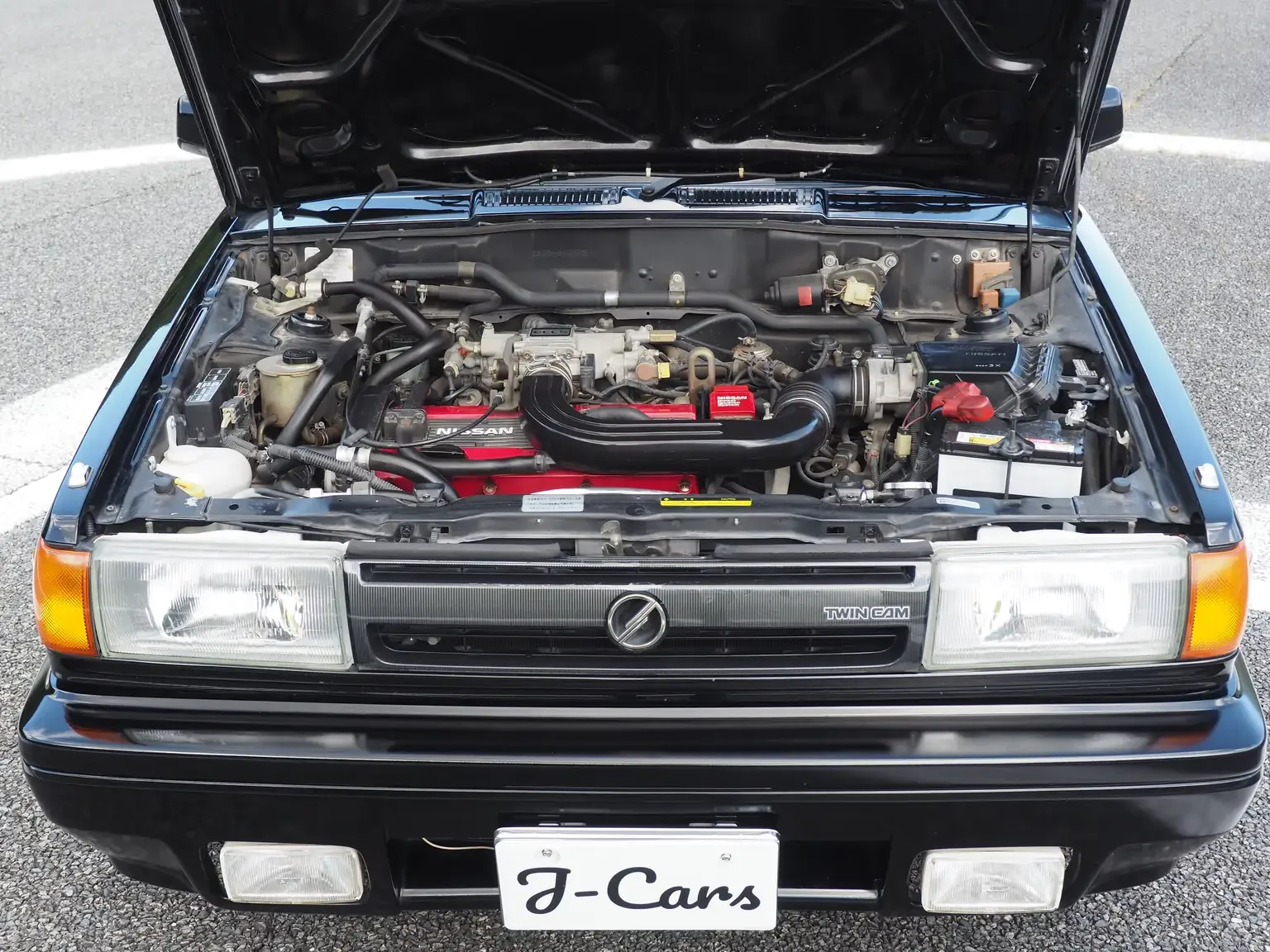 bonnet-open-showing-ca16de-engine-view-1989-nissan-sunny-super-saloon-twin-cam-nismo-eb12-jdm-export-vehicle-japan.webp