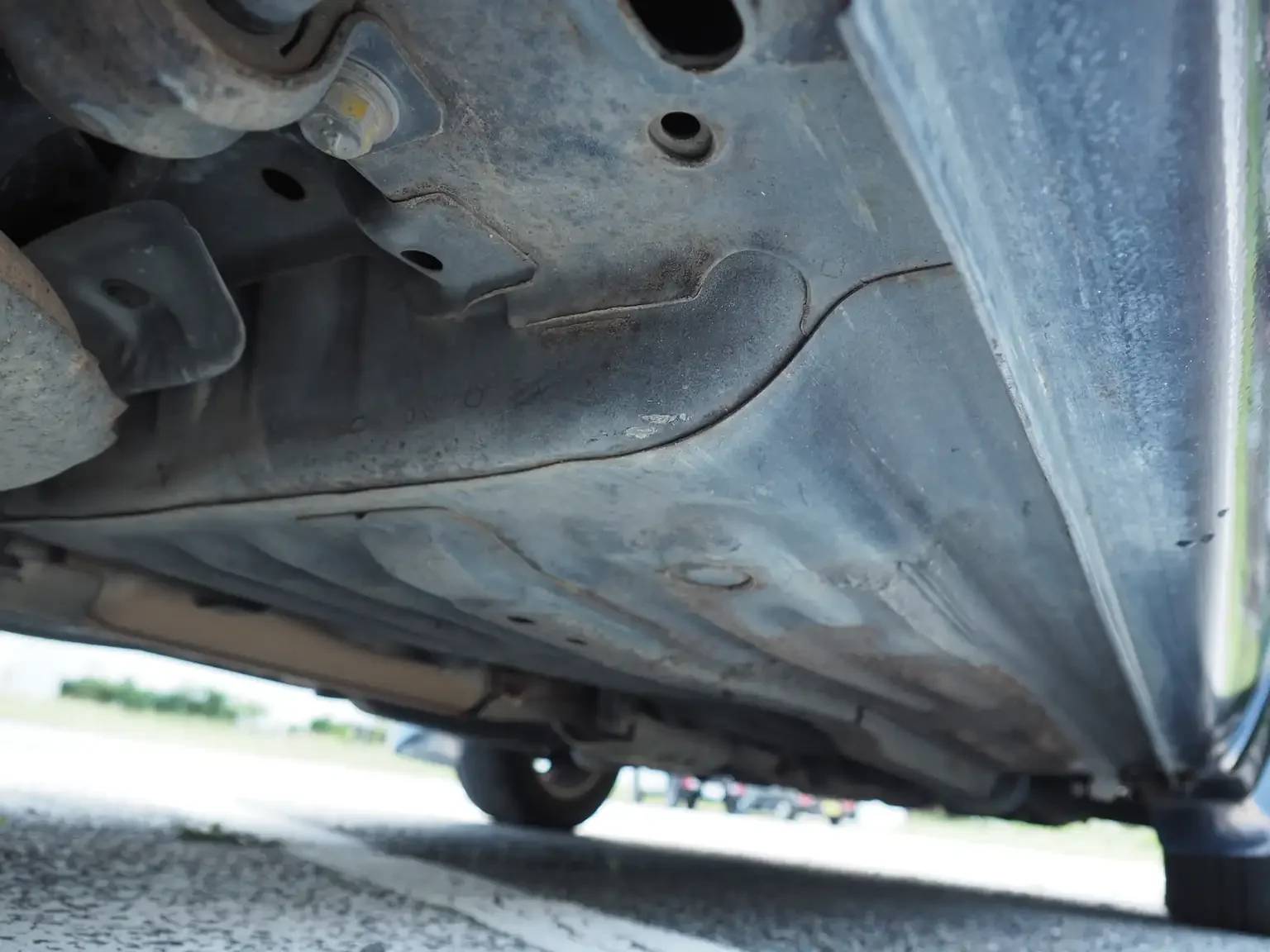 drivers side undercarriage condition view of 1989 Nissan sunny super saloon twin cam NISMO in black jdm export vehicle Japan