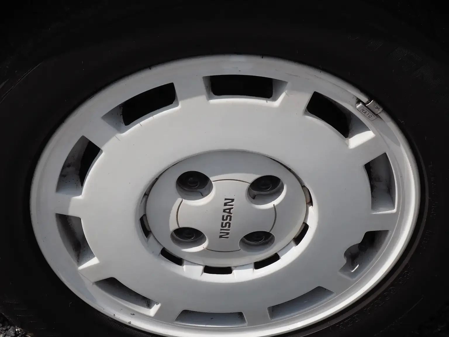nismo 14 inch white alloy wheel view of 1989 Nissan sunny super saloon twin cam NISMO in black jdm export vehicle Japan