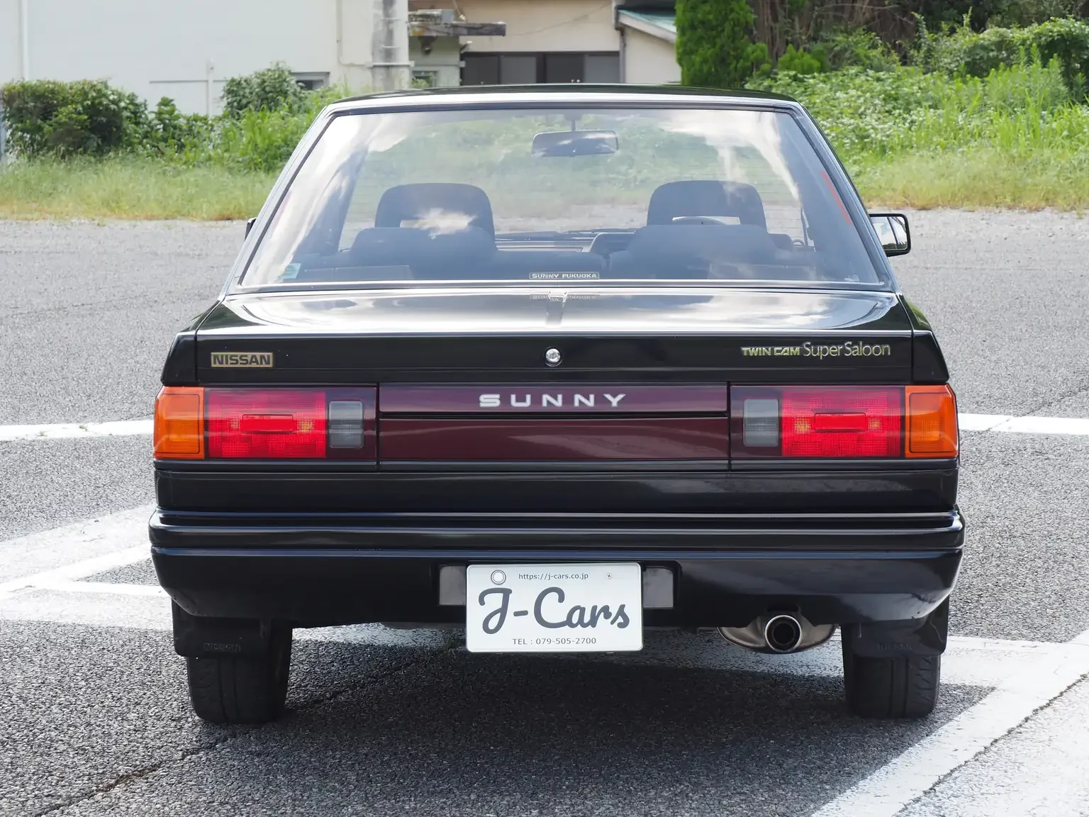 rear end view view of 1989 Nissan sunny super saloon twin cam NISMO in black jdm export vehicle Japan
