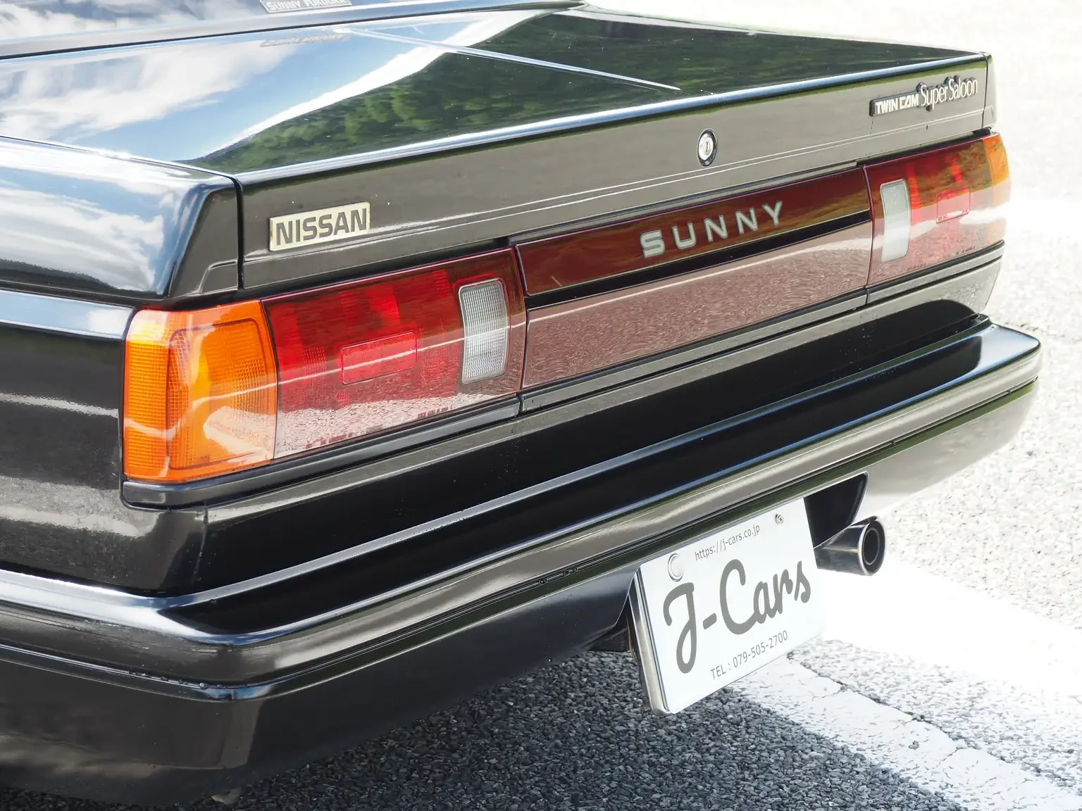 tail light cluster view of 1989 Nissan sunny super saloon twin cam NISMO in black jdm export vehicle Japan
