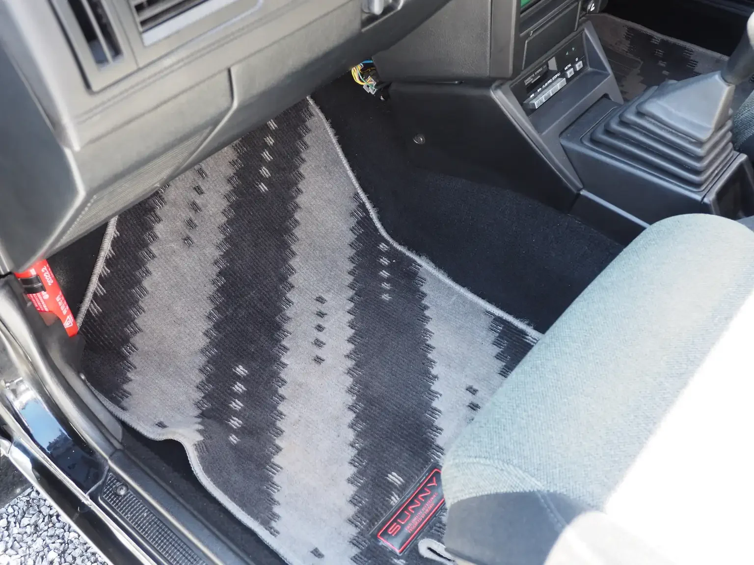 floor mat passengers view of 1989 Nissan sunny super saloon twin cam NISMO in black jdm export vehicle Japan