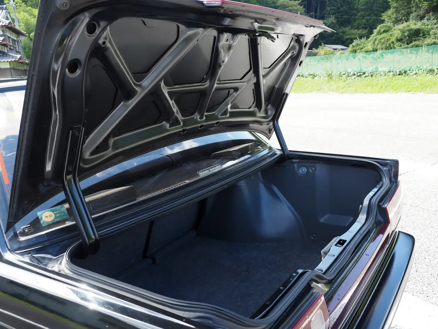 trunk room view of 1989 Nissan sunny super saloon twin cam NISMO in black jdm export vehicle Japan